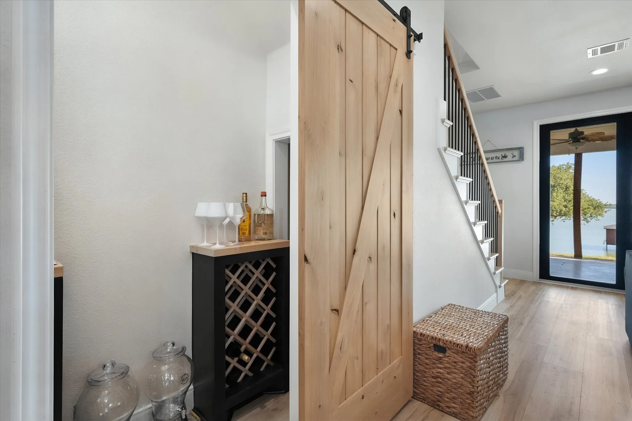 Stylish interior nook with sliding barn door and beverage storage adds character and functionality to this Richland Chambers Lake home.