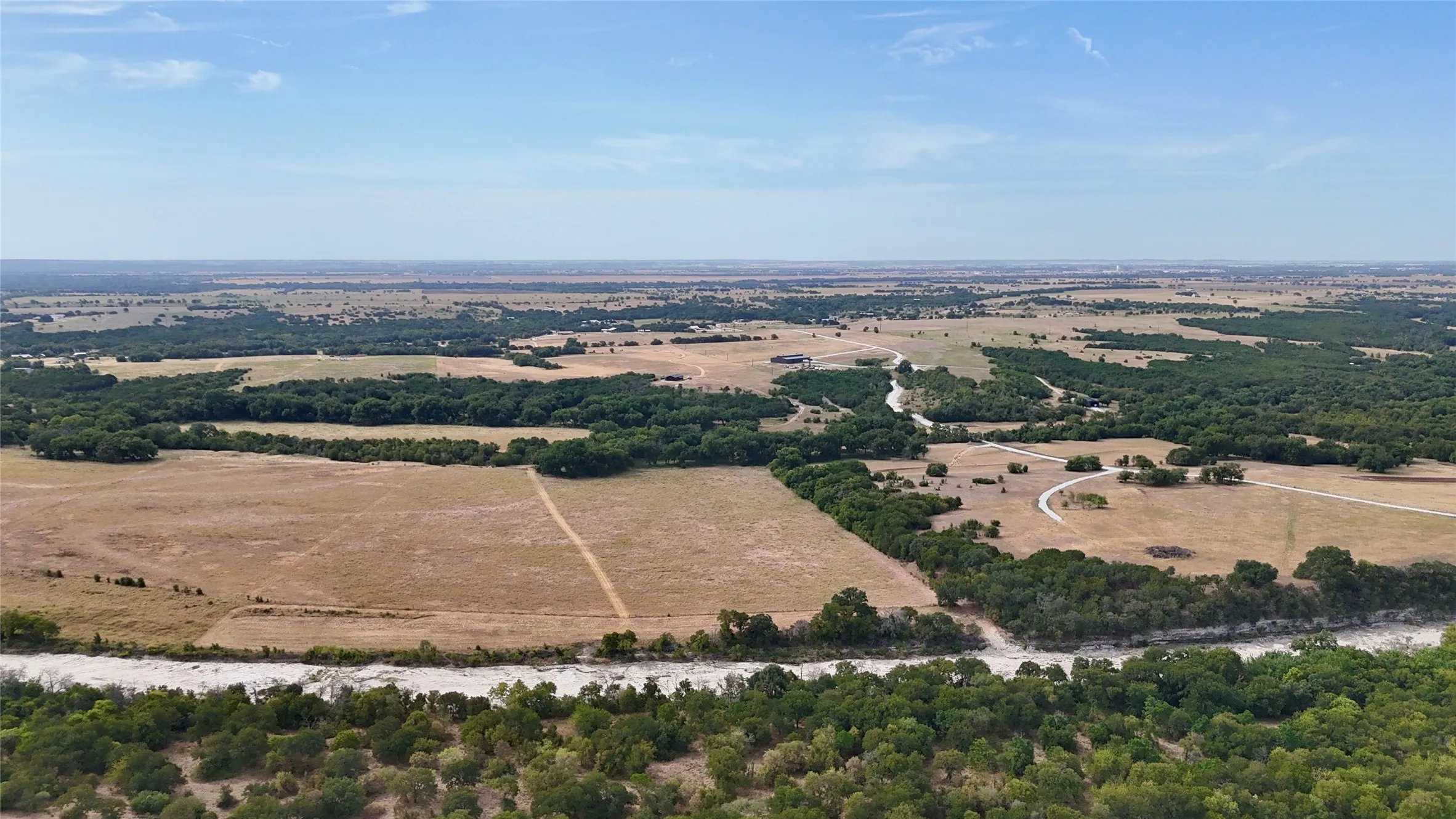 Extensive acreage featuring diverse terrain, mature tree lines, and open fields