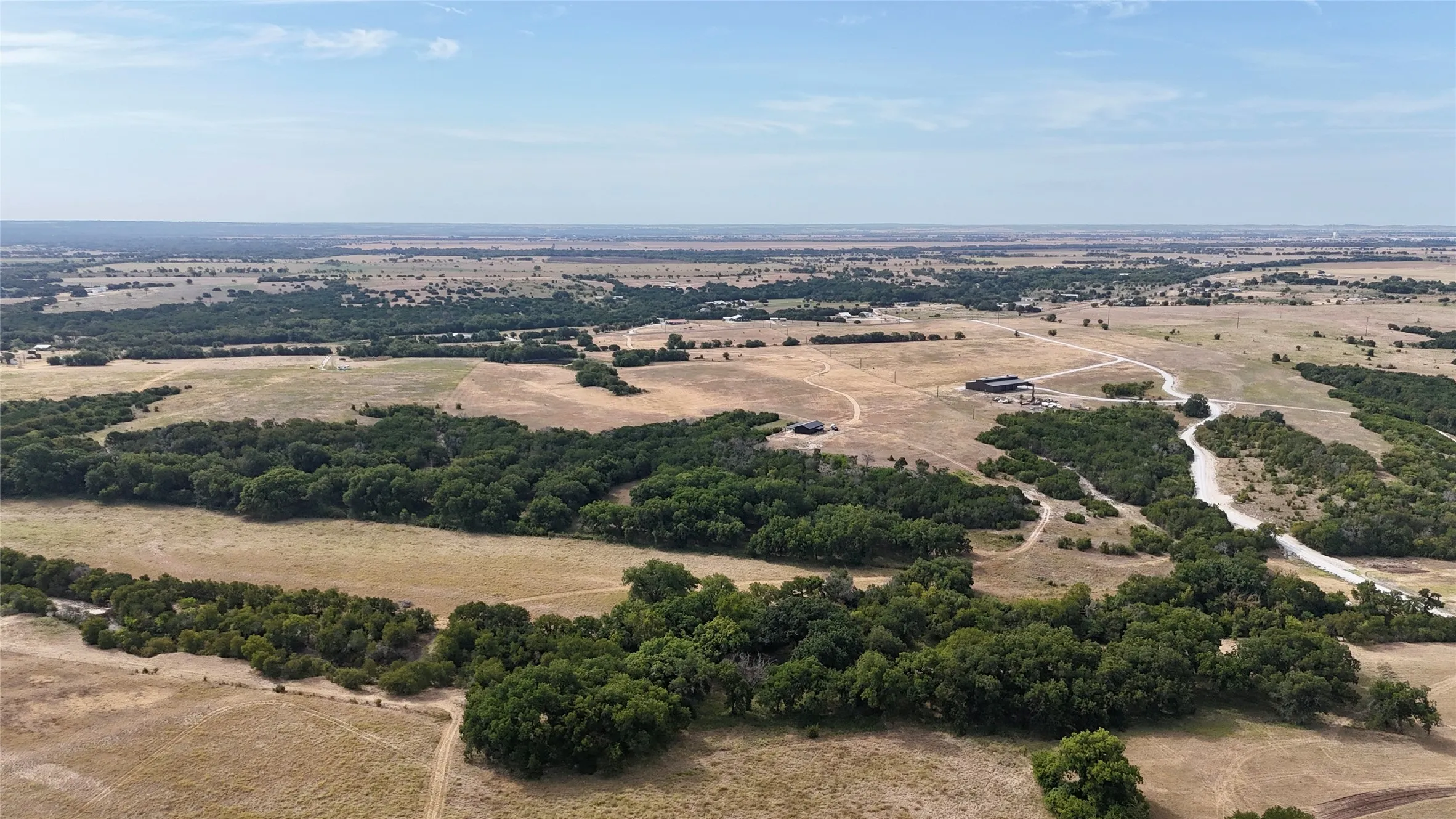 Expansive acreage featuring natural tree lines and open fields