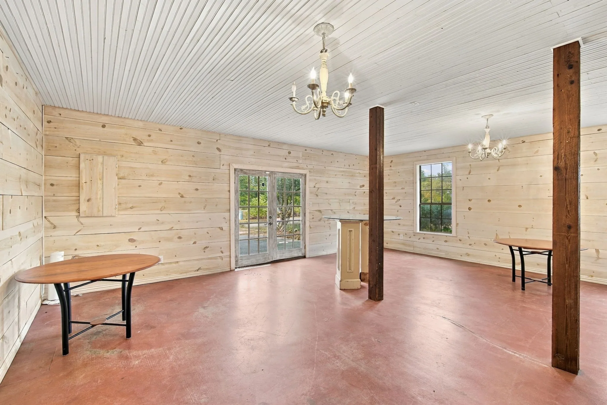 Boutique with shiplap pine walls, chandeliers and stained concrete- opening with double doors to original drive and a walk through door to house.