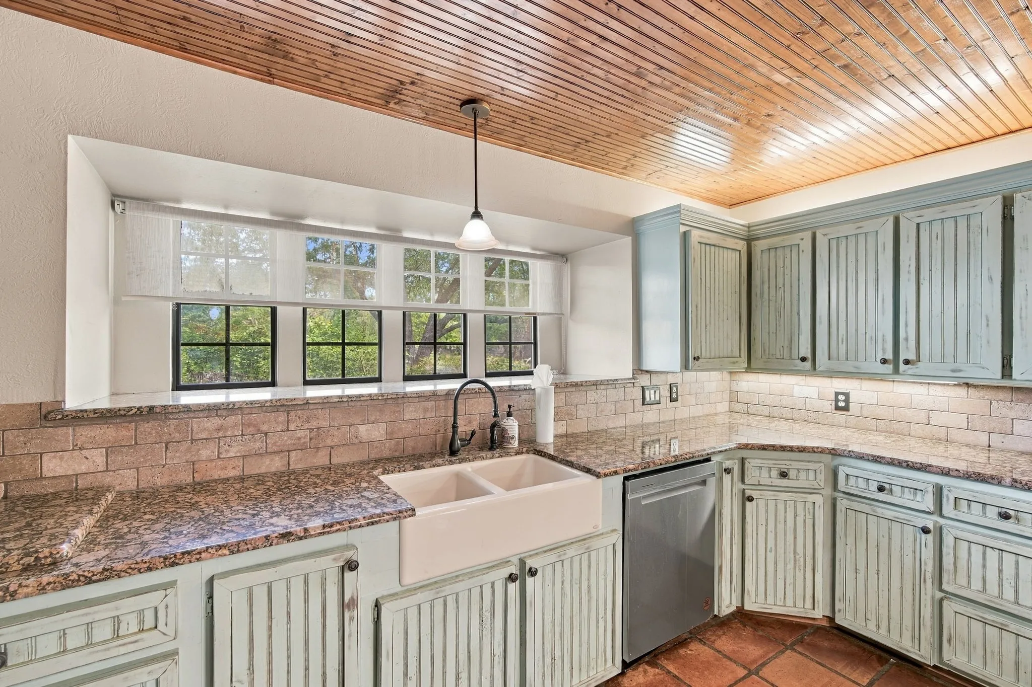farmstyle blue cabinets with farm sink add to the English Tudor Style