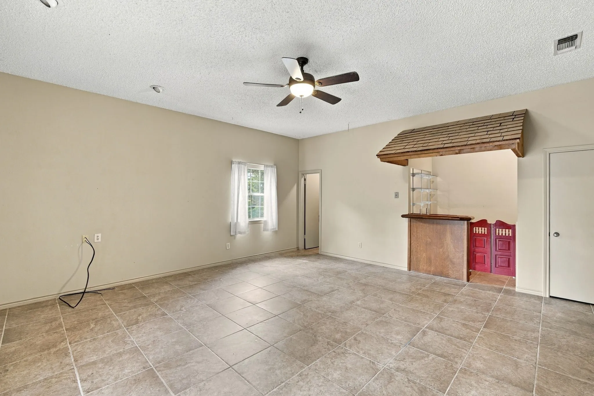 Multi generational living space! Large room with room for Bed and sitting area, wetbar complete with minifridge, sink and countertop space with open shelving, walk in closet and full bath with double doors exiting to backyard.