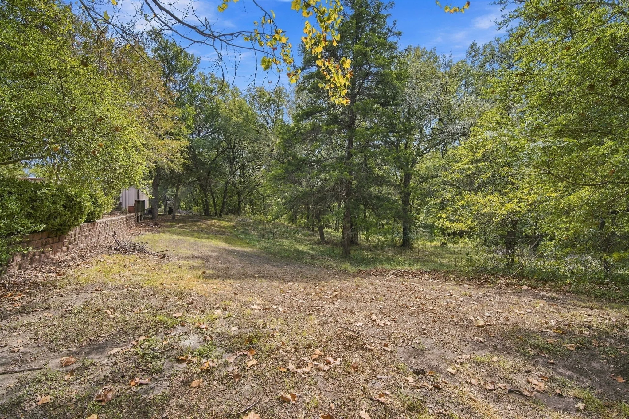 leading back to the wooded acres.