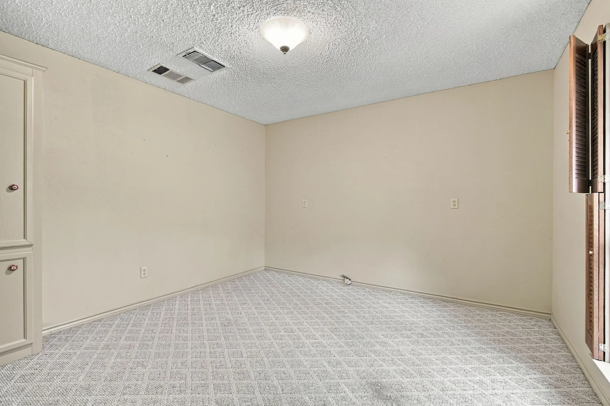 Secondary bedroom located near boutique-used as dressing room. Builtins serve as closet space.