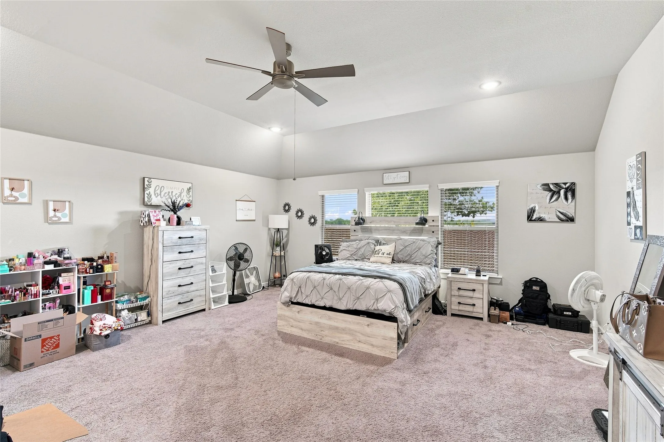 Tray ceiling with a ceiling fan, recessed lighting, and multiple windows