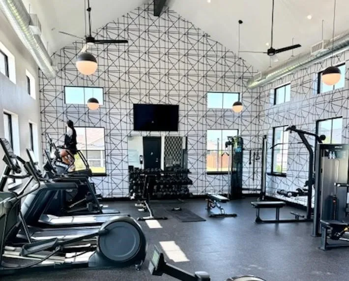 Spacious fitness center featuring vaulted ceilings and extensive natural light