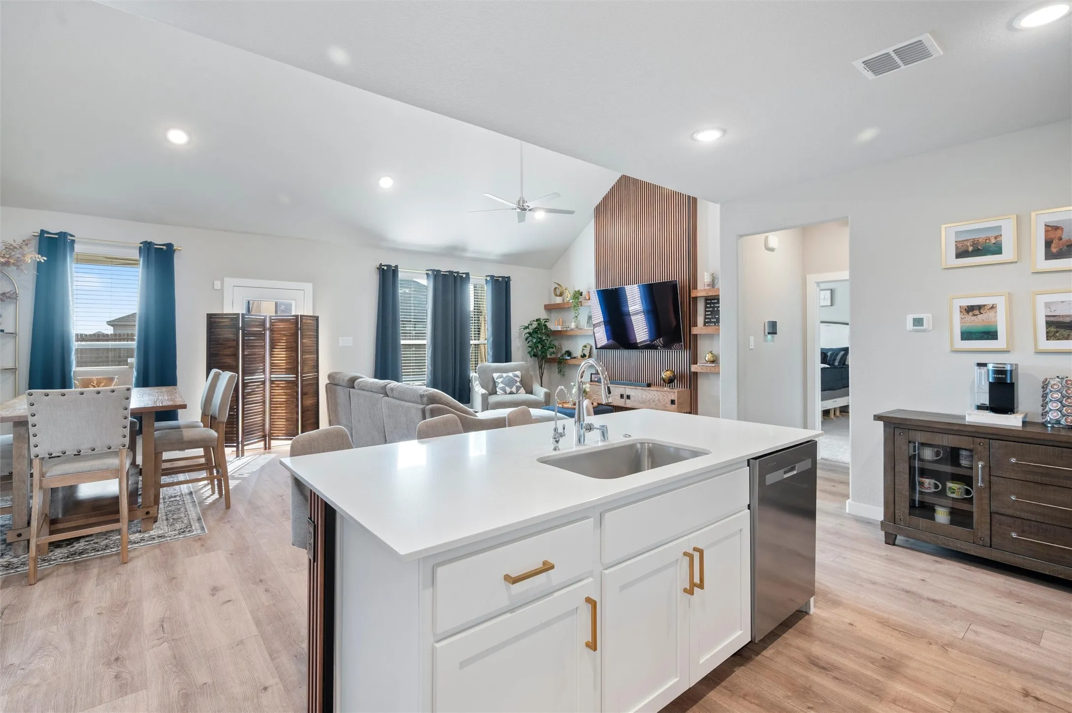 Kitchen island with a built-in sink and stainless steel dishwasher