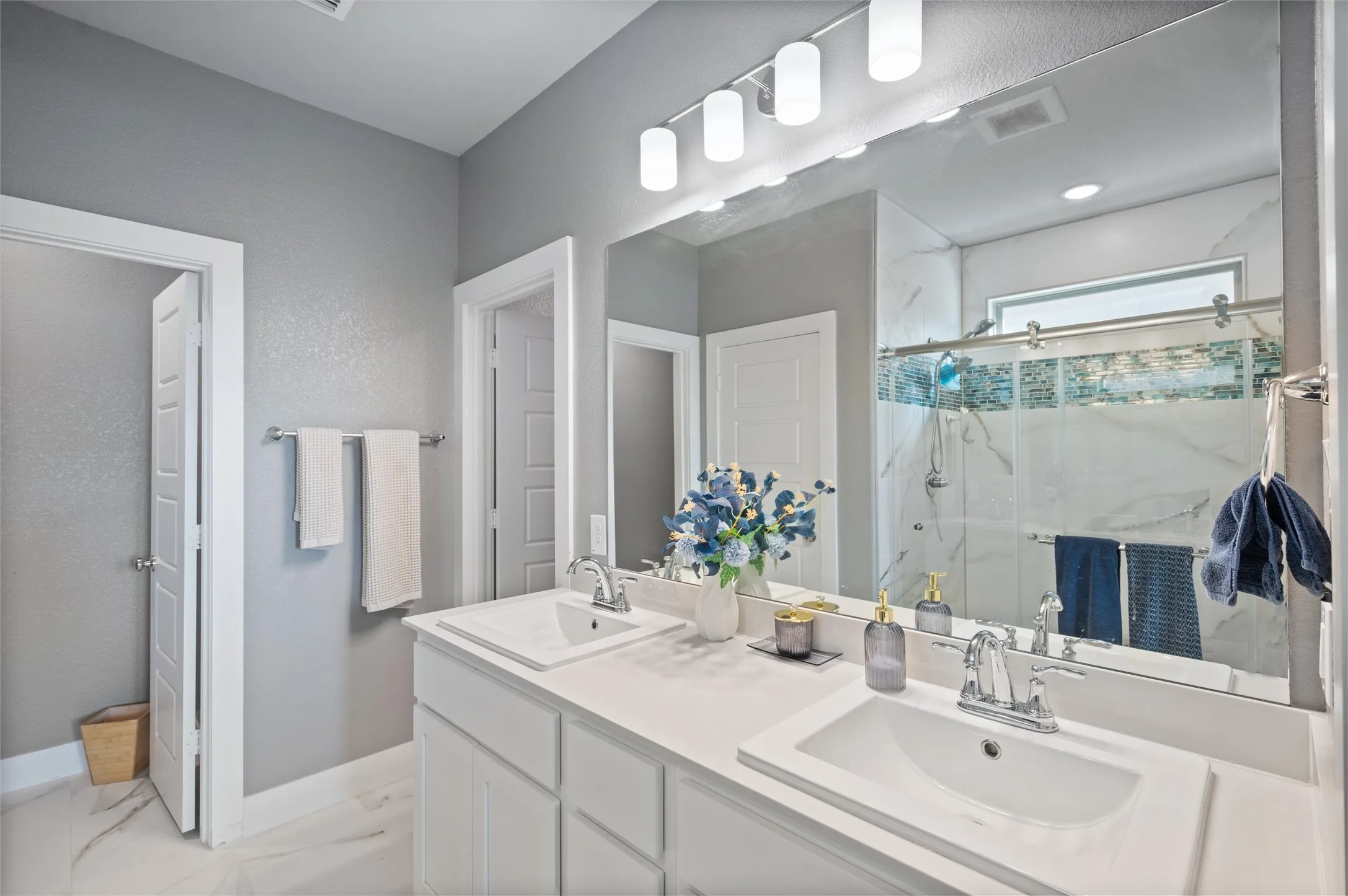 Dual vanity with undermount sinks and chrome fixtures