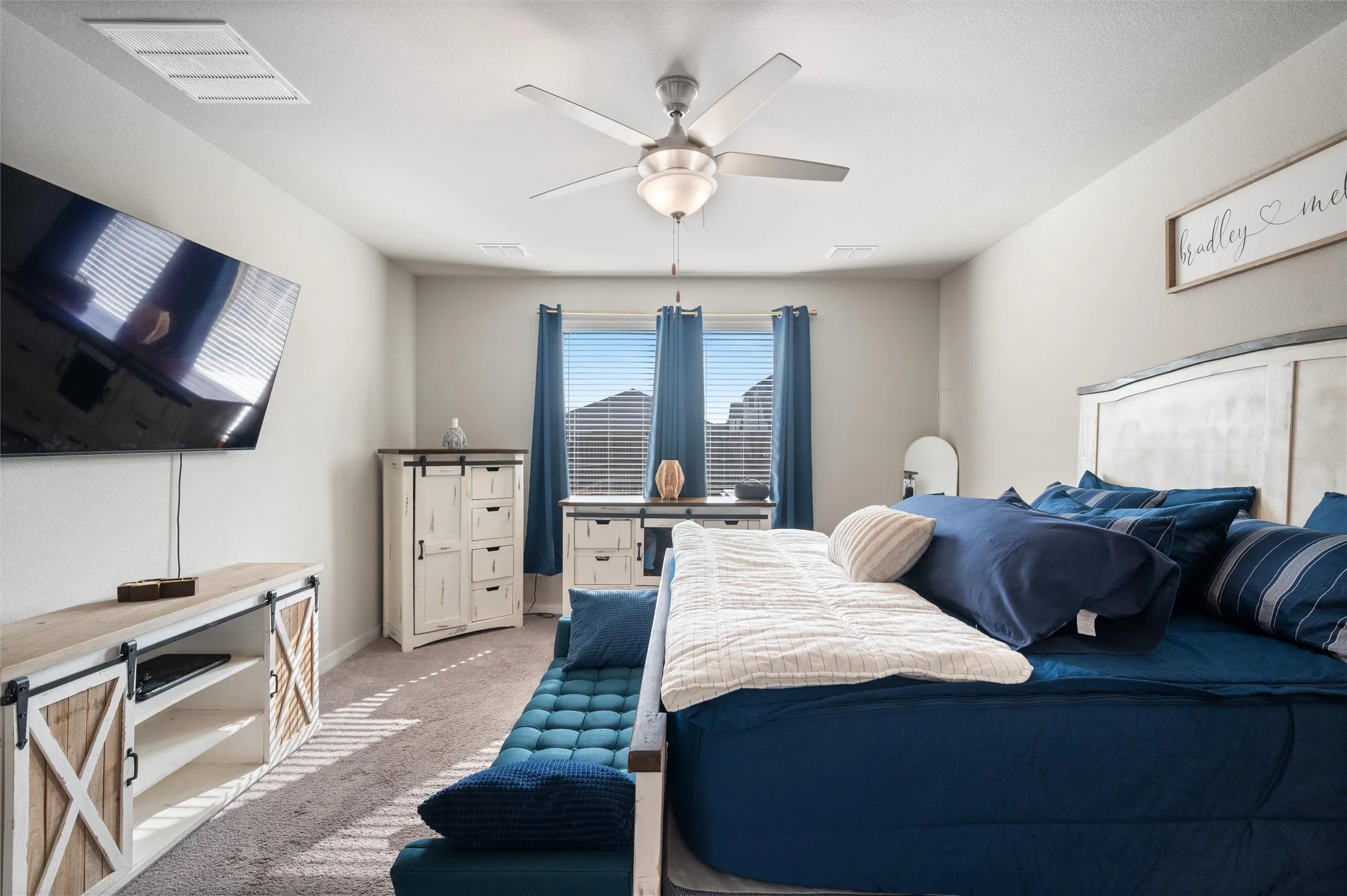 Recessed lighting, ceiling fan, carpeted flooring, and window treatments