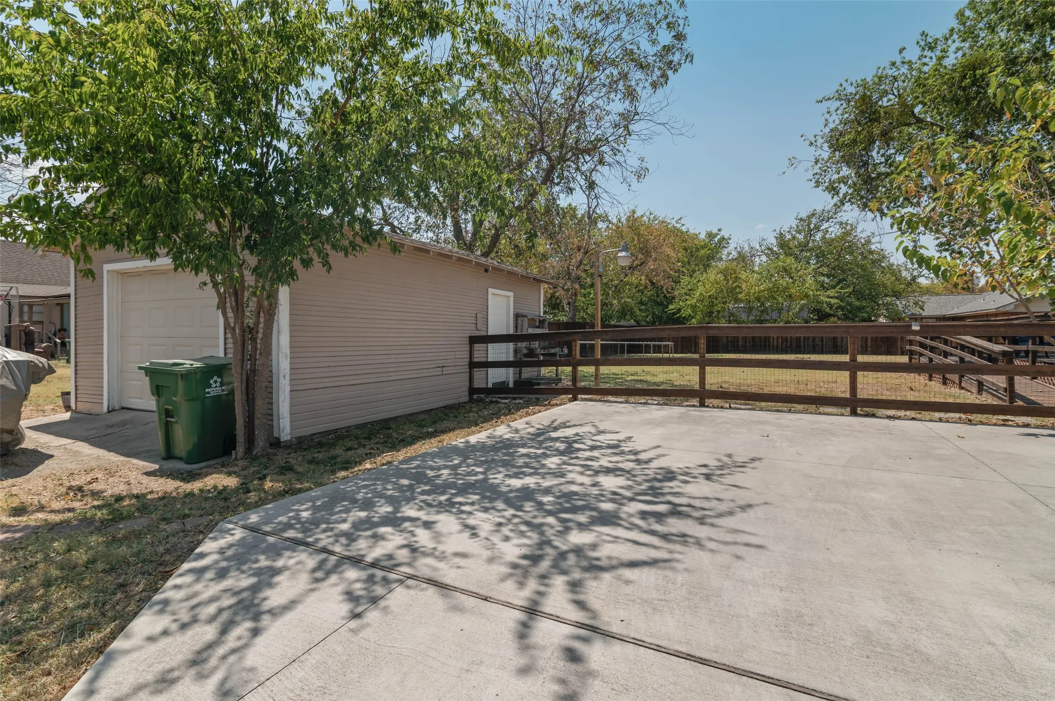 One car garage and concrete driveway.