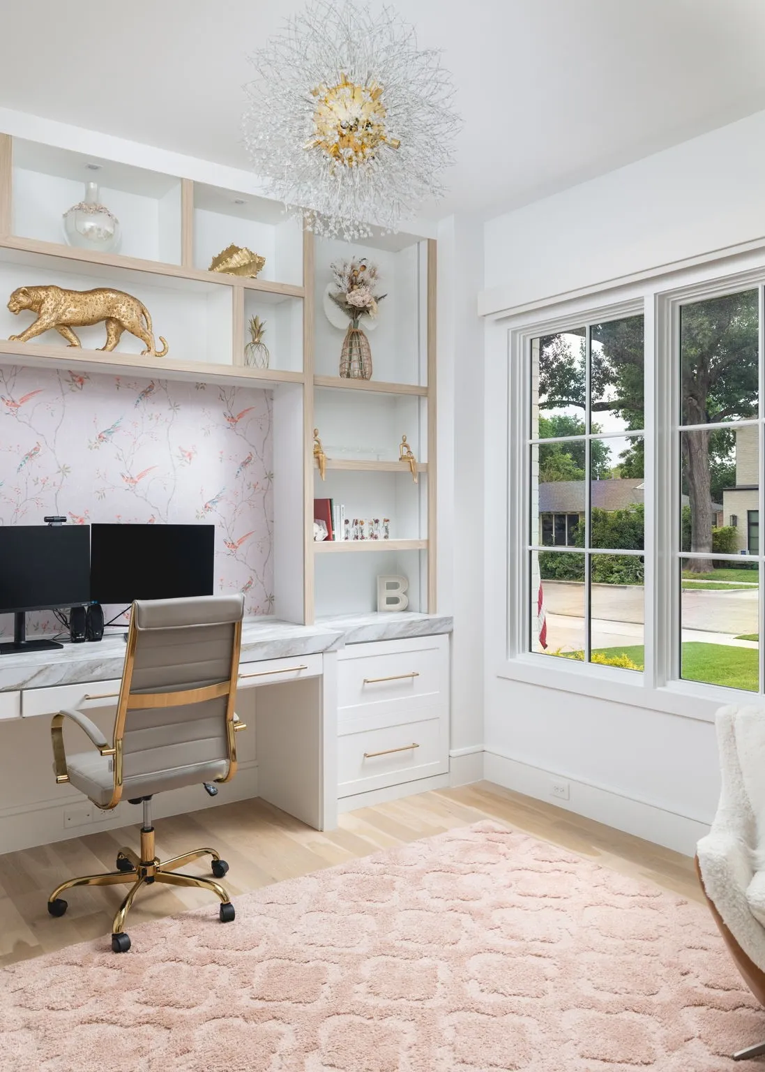 Built-in desk with a stone countertop and integrated custom cabinetry