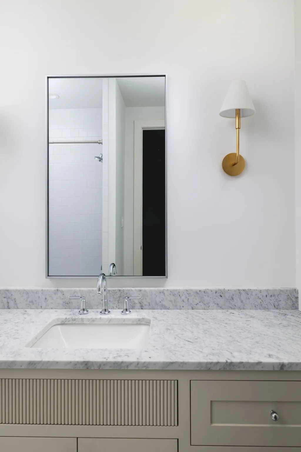 Spa-inspired bathroom vanity featuring a light stone countertop, integrated undermount sink, and polished chrome faucet