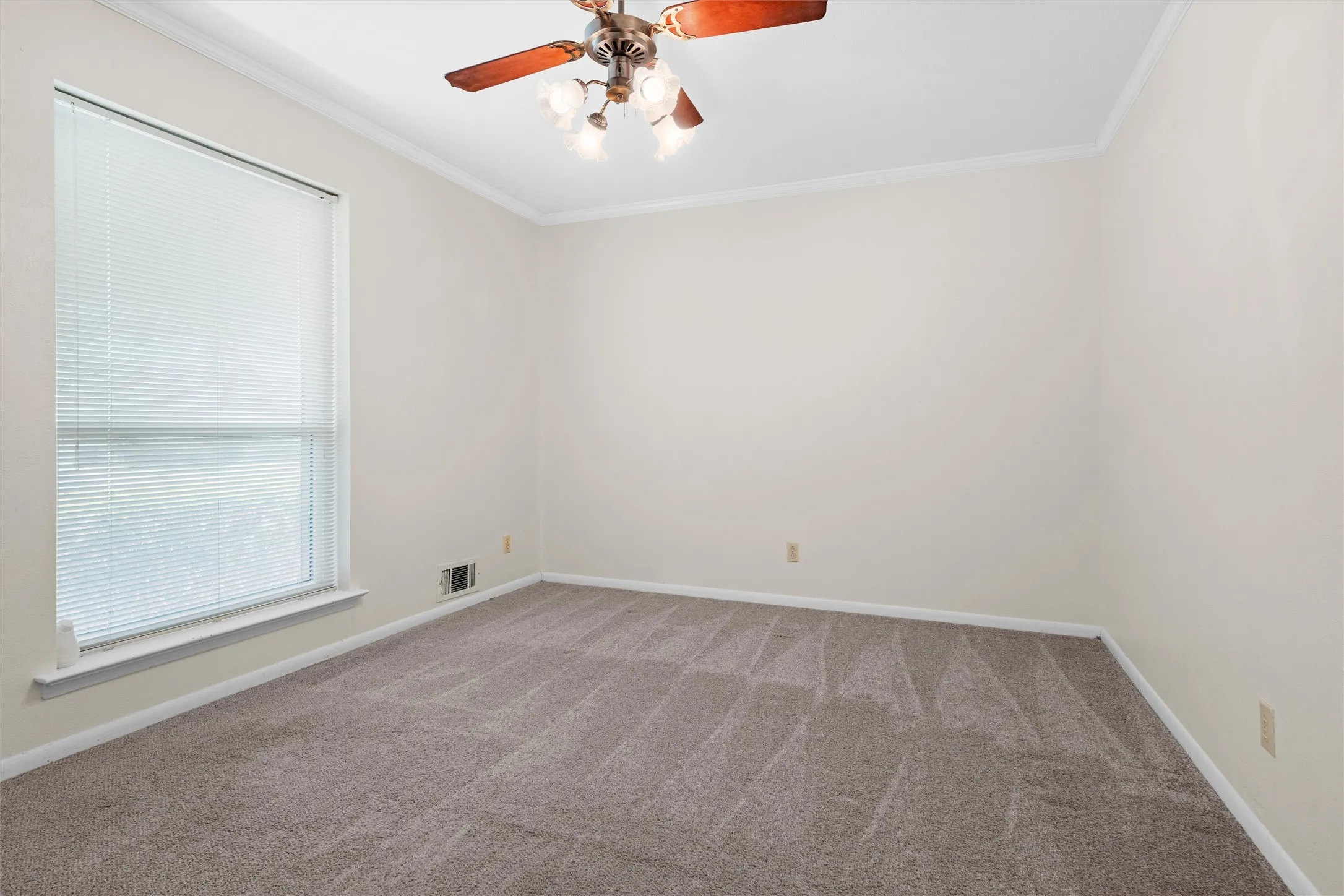Neutral wall tones, crown molding, ceiling fan with integrated lighting, window with blinds, and carpeted flooring