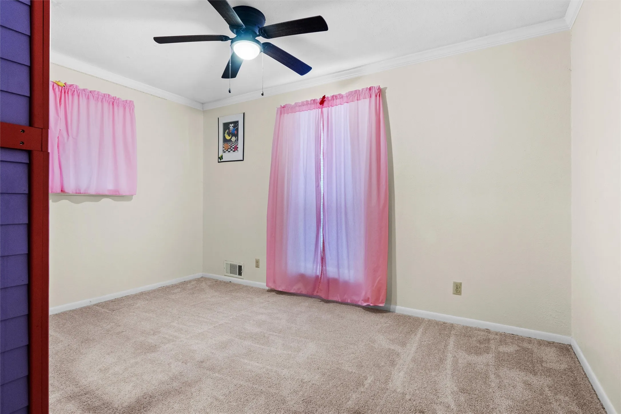 Neutral wall color with white crown molding and baseboards