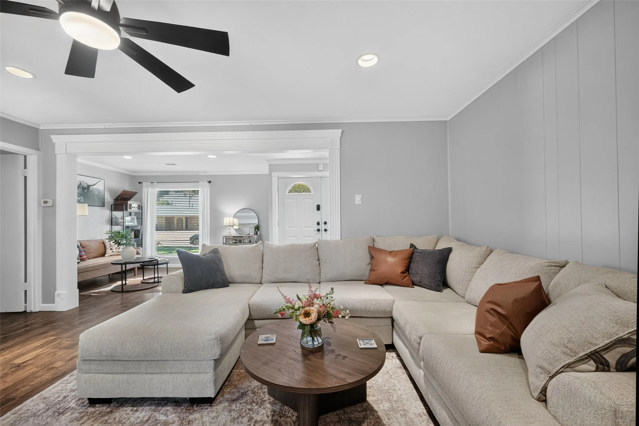 Recessed lighting, wood-finish flooring, ceiling fan, decorative trim, and board and batten accent wall