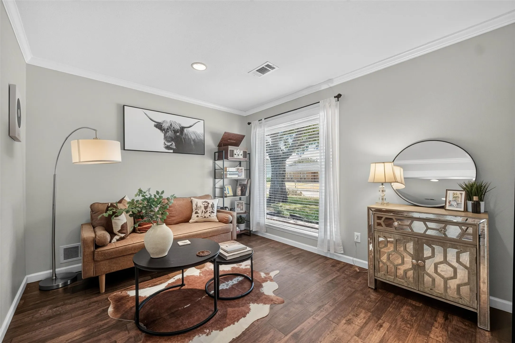 Wood-finish flooring, crown molding, and recessed lighting