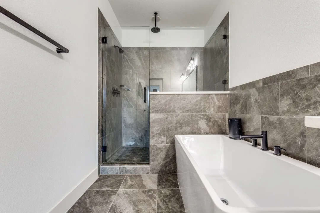 Master bath shower+tub combo with two showerheads.
