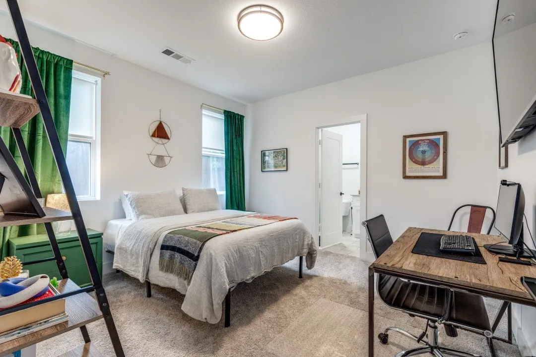 First floor guest bedroom/office w/ full ensuite bath and walk-in closet.