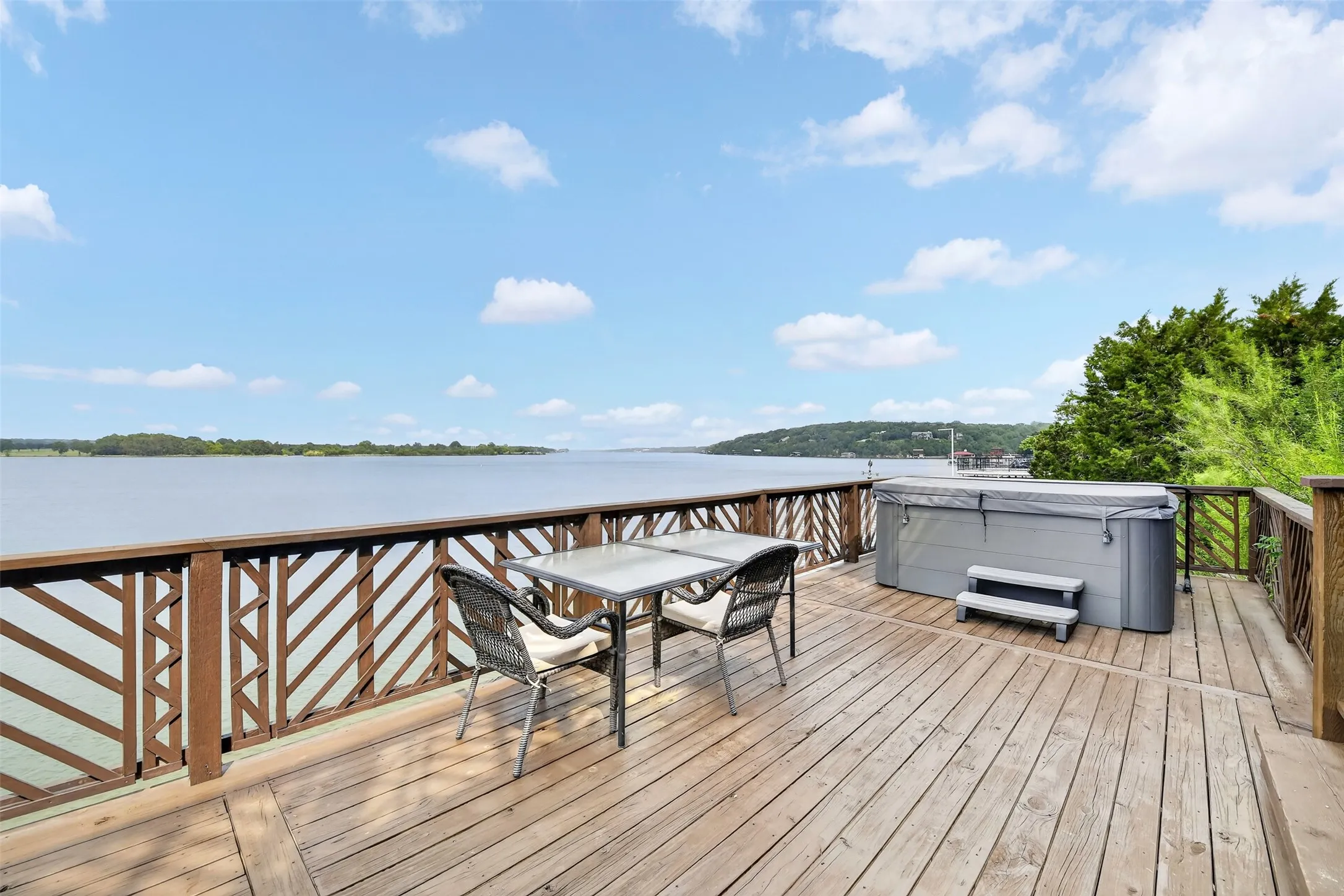 Large deck area with a hot tub