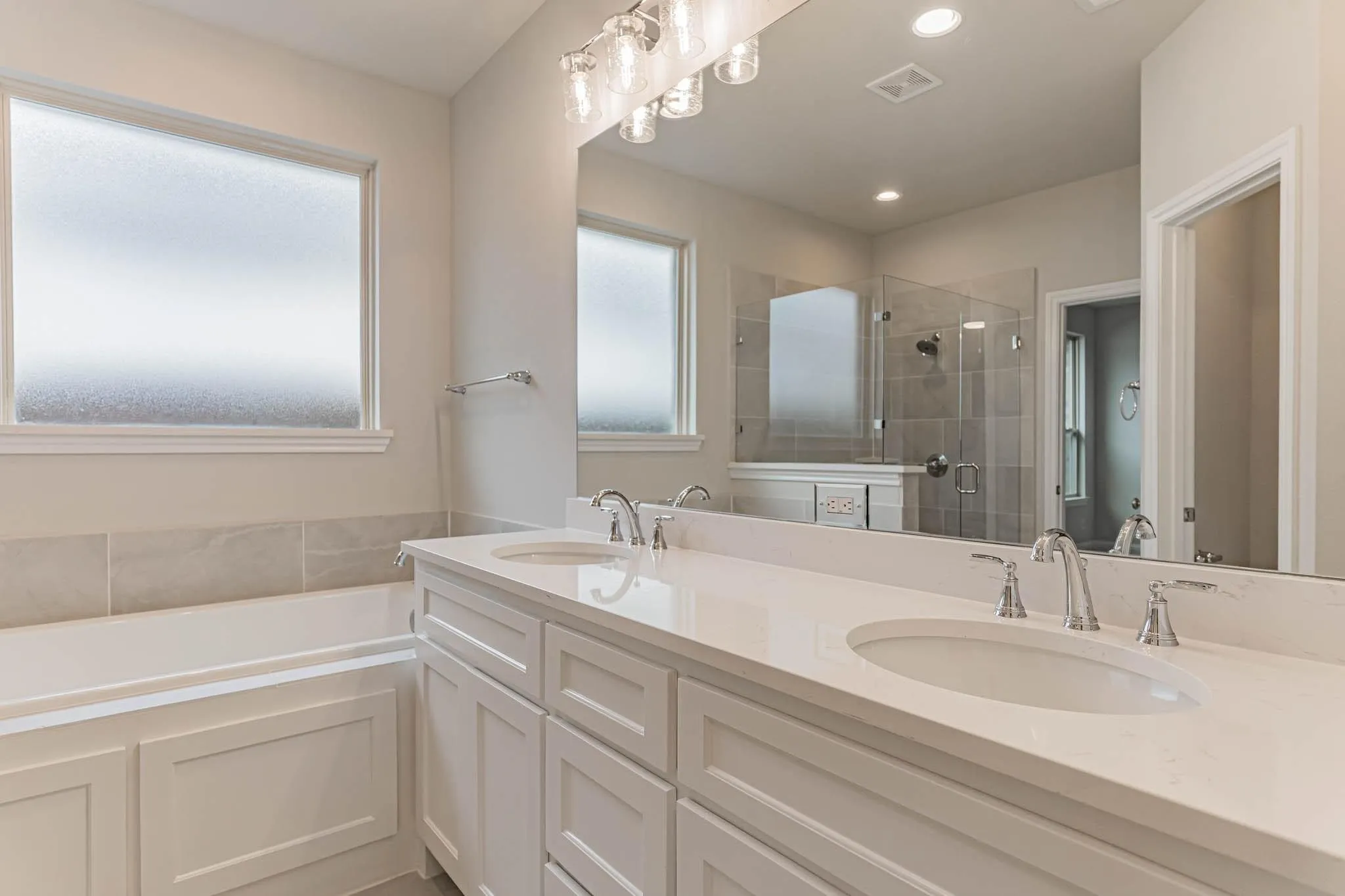 Dual vanity with undermount sinks and polished chrome fixtures