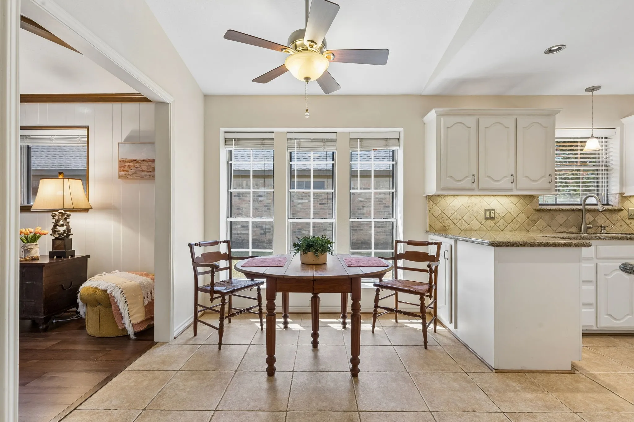 Kitchen featuring tile flooring, white cabinetry, a tiled backsplash, and recessed lighting