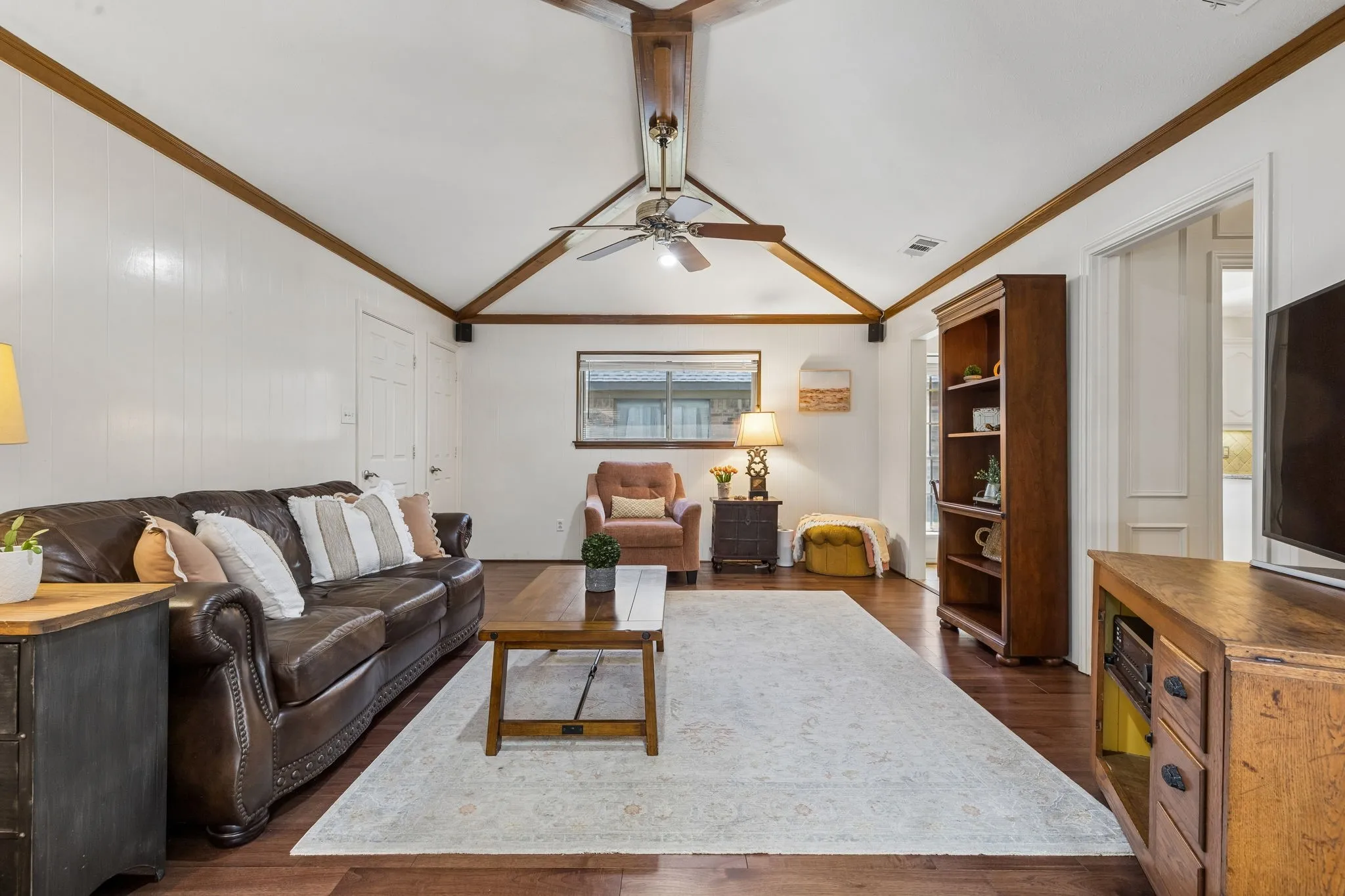Family room with wood floors and beamed ceiling
