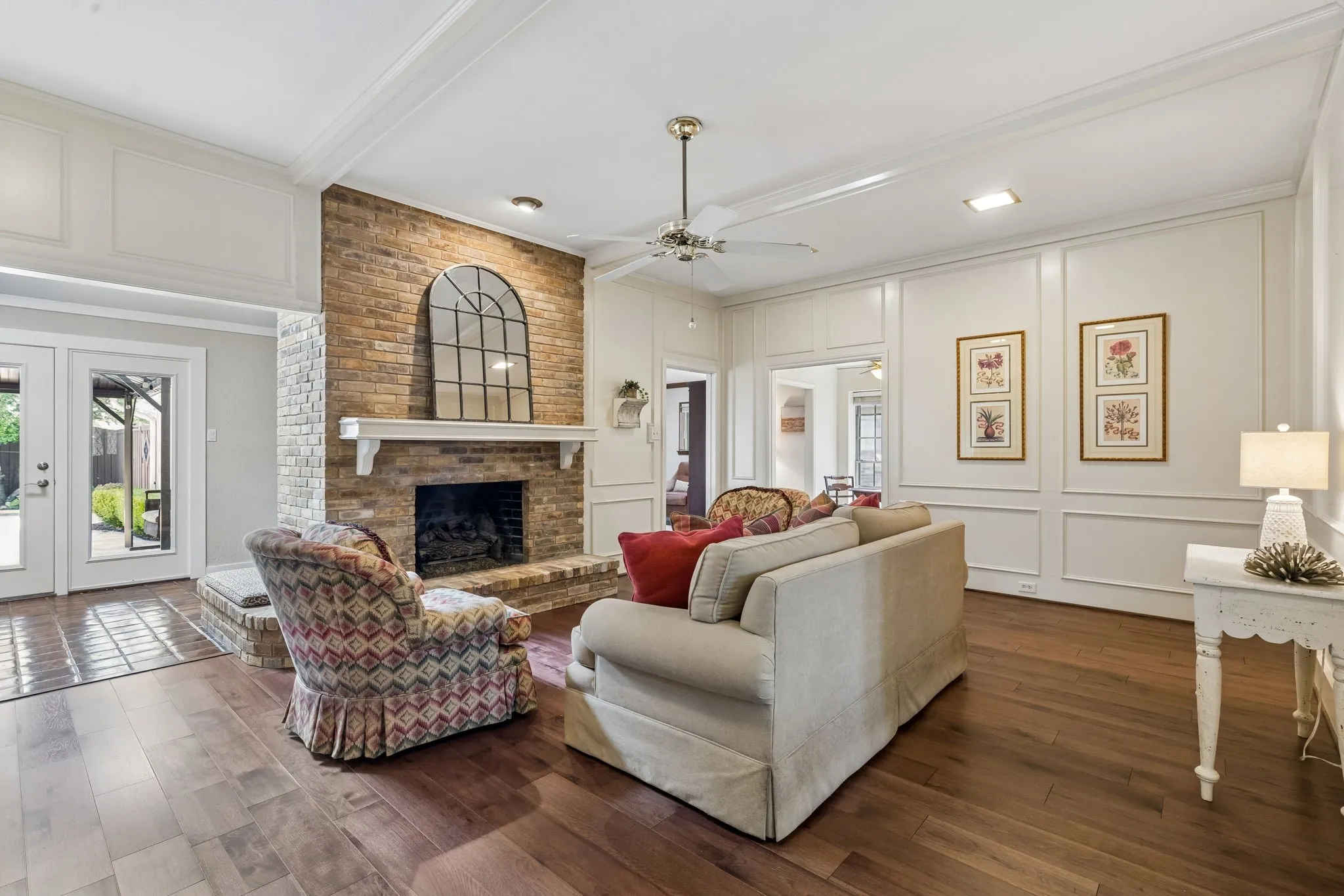 Living room with brick fireplace and wood floors