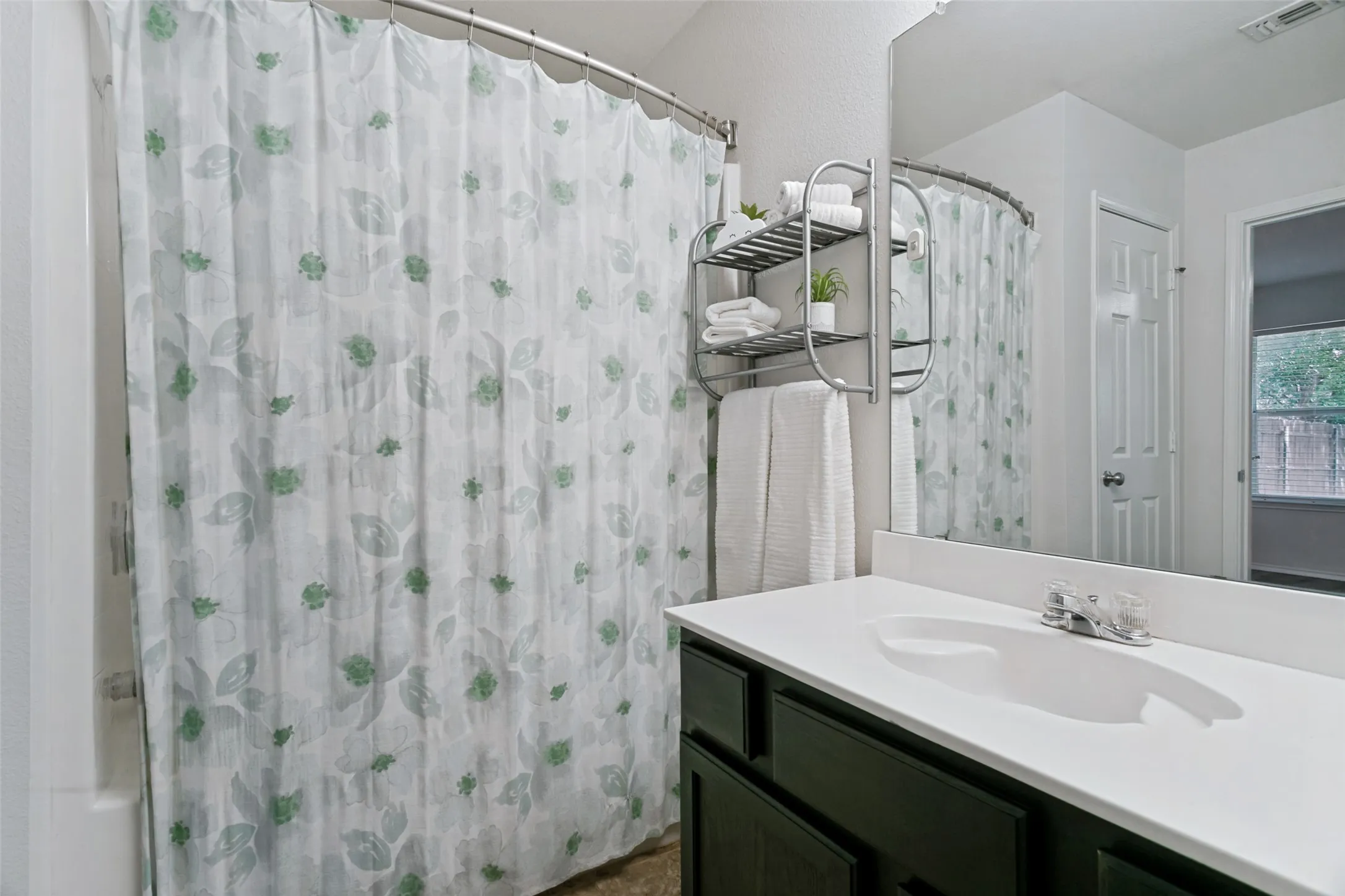 Built-in vanity with single basin sink and a spacious countertop