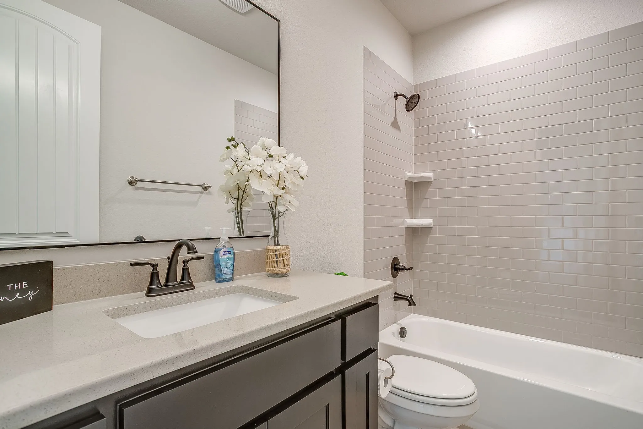 Built-in vanity with light-toned countertop and under-mount sink