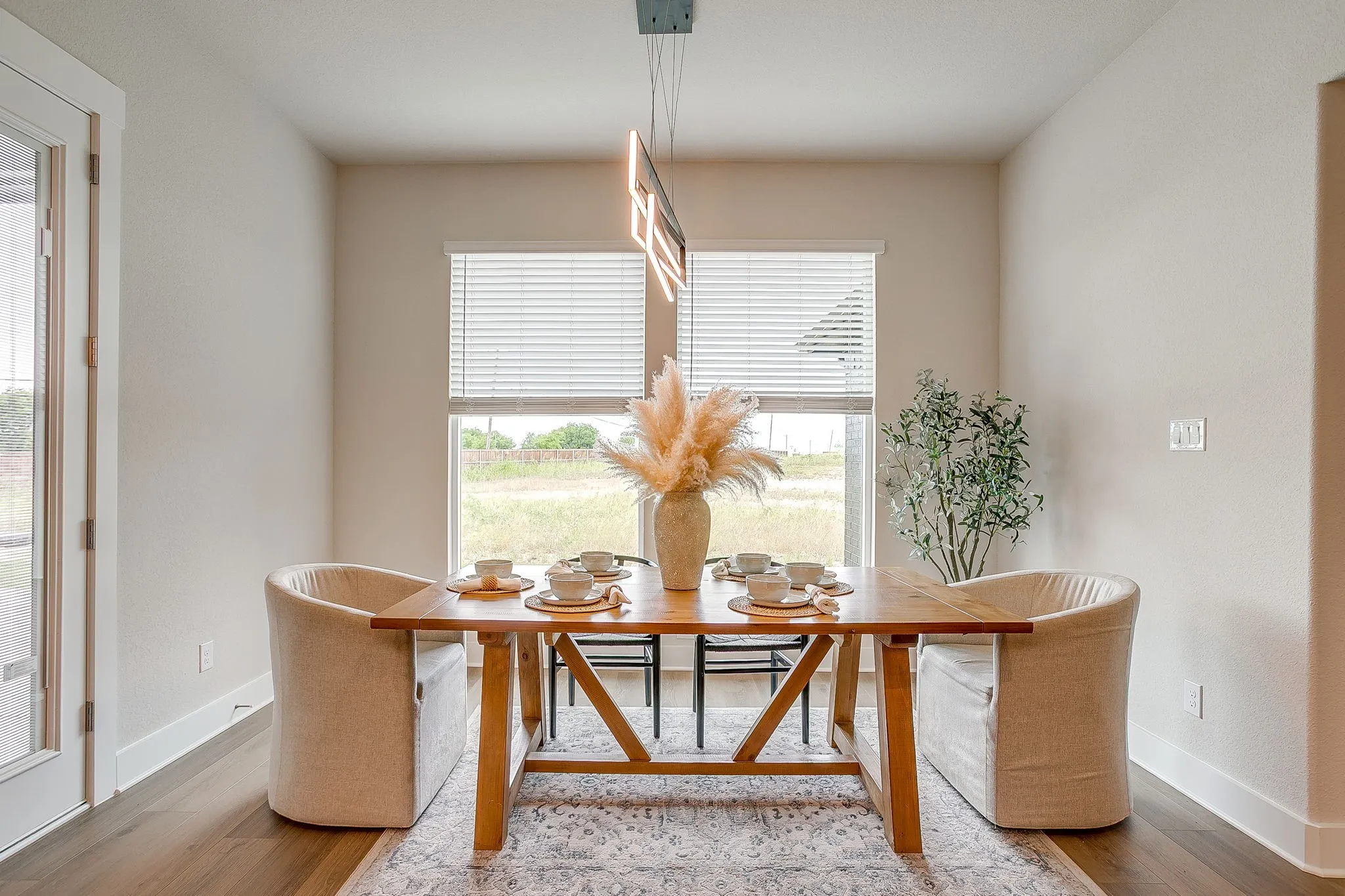 Wood-finish flooring, recessed lighting, and a modern rectangular chandelier
