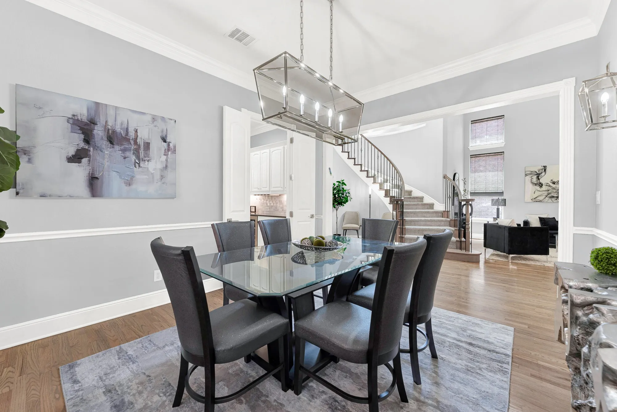 This wide angle reveals how beautifully the open dining space flows directly into the main living areas and elegant entryway. Your friends will love the airy, connected layout that makes mingling from room to room during gatherings seamless and fun for everyone.