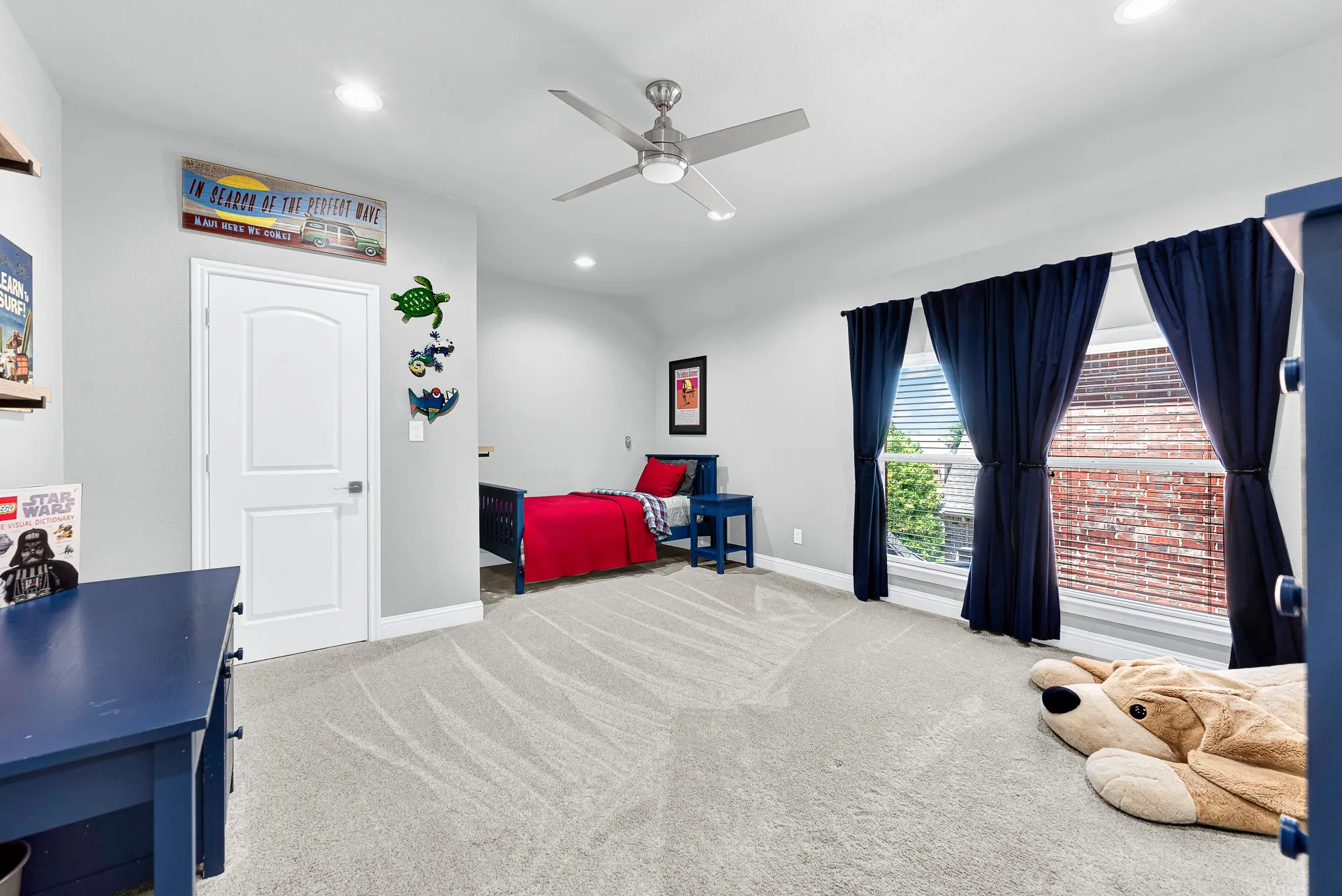 Another spacious upstairs guest bedroom features soft carpeting, high ceilings, bright windows, and easy access to the main staircase, media room and game room. Provide overnight visitors with an inviting, comfortable space where they can feel right at home.