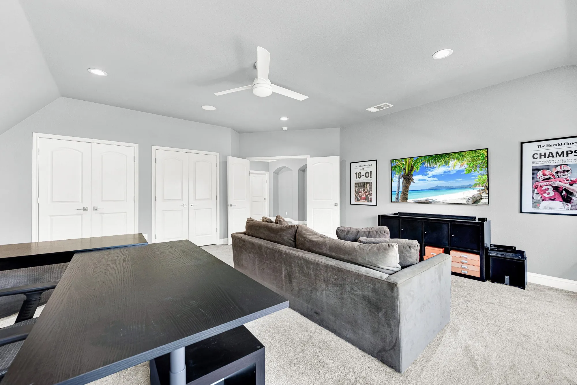 Double closets line the far wall of this expansive bonus room, complete with recessed lighting and a sleek ceiling fan overhead. Enjoy the flexibility of using this room as a dedicated home office, casual media space, play room, or a private extra bedroom setup