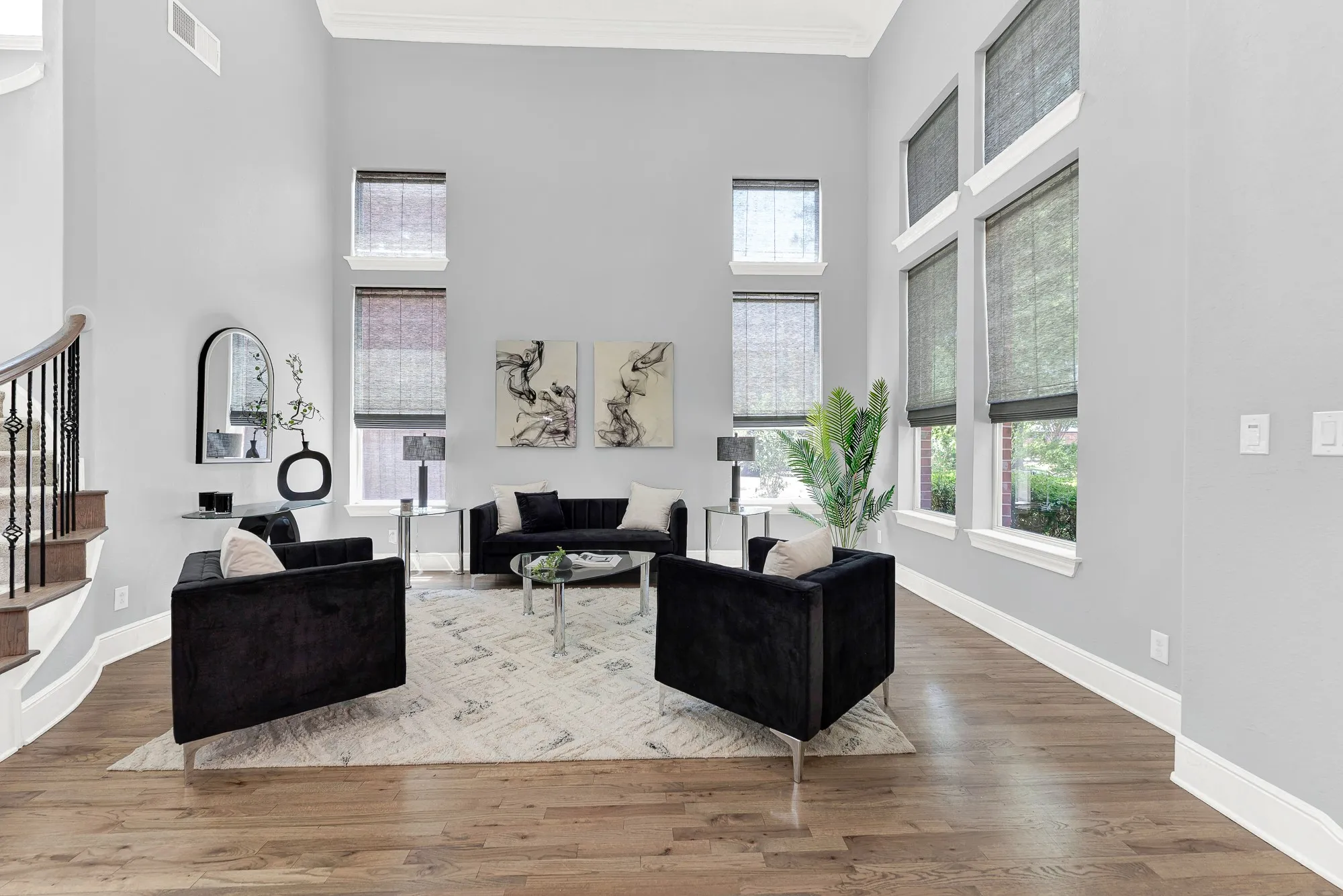 Massive two-story, sun-drenched windows frame tranquil tree-lined views, while the elegant wood flooring provides a warm, natural contrast. Relax on the sofa for peaceful morning coffee and reading, bathed in lovely natural sunlight that fills the entire home.