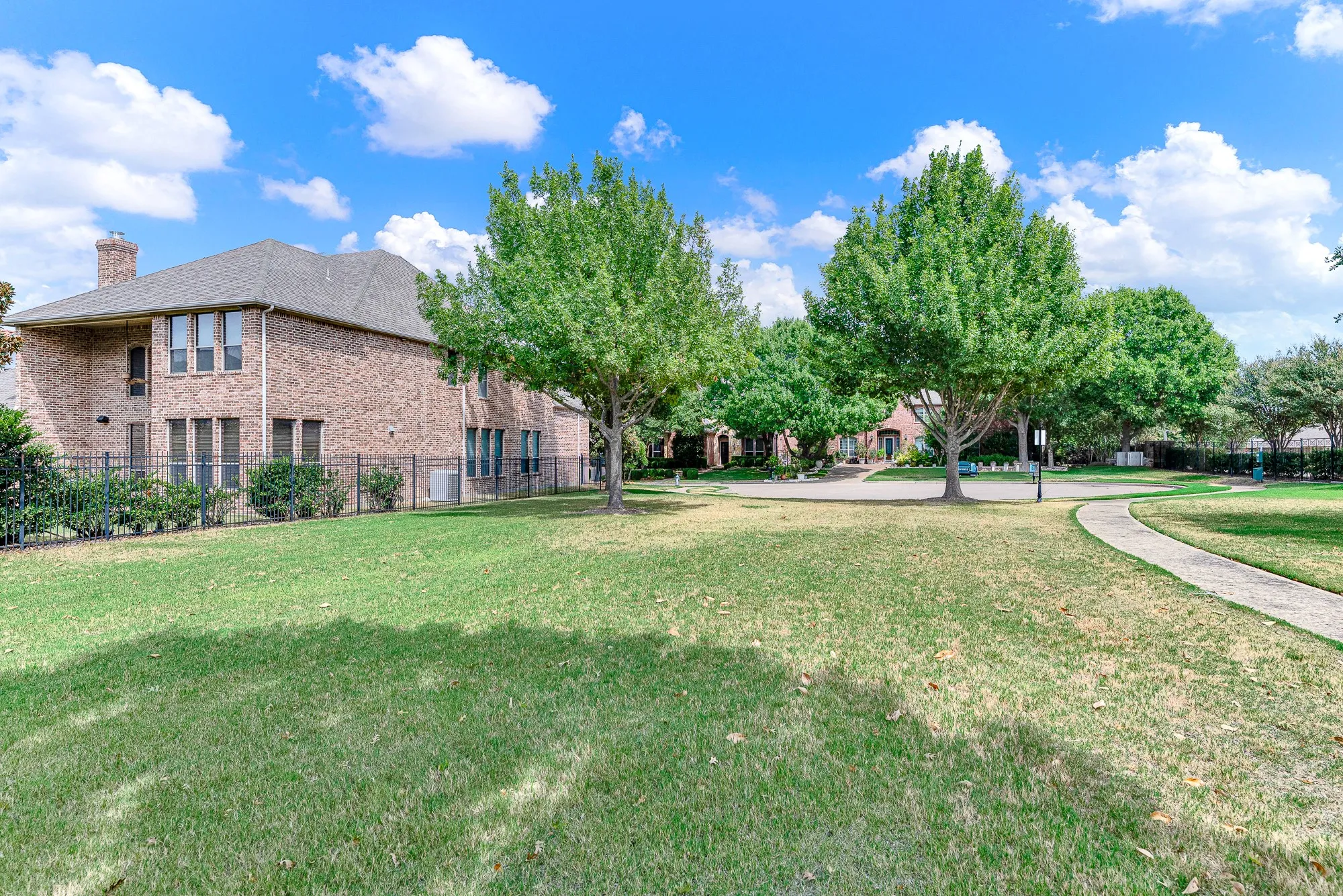 Beautifully maintained lawn and a winding sidewalk, offering a peaceful and inviting setting for the home