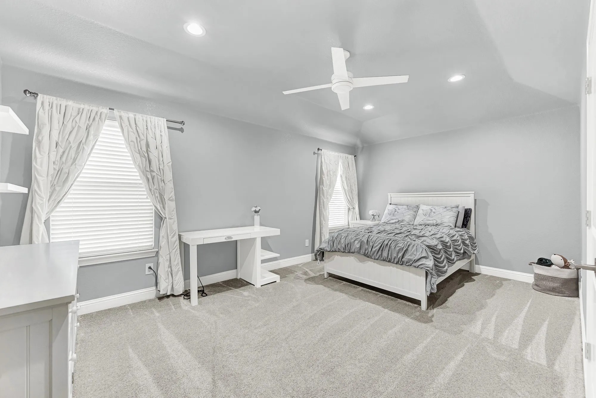 This spacious upstairs guest bedroom features soft carpeting, high ceilings, bright windows, and easy access to both the game room and back staircase. Provide overnight visitors with an inviting, comfortable space where they can feel right at home.