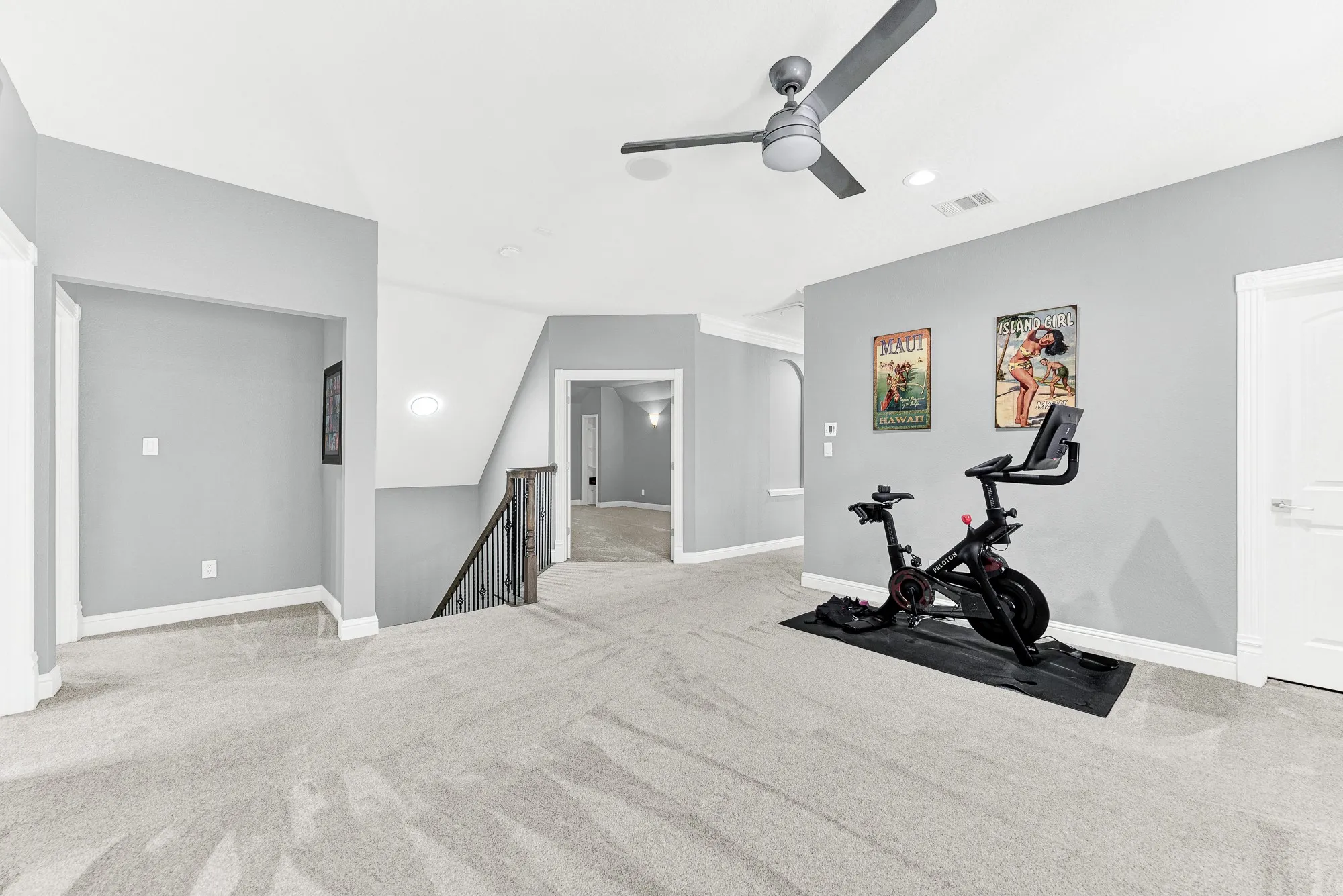 Overlooking the wrought-iron staircase landing, this open layout connects seamlessly toward the adjacent media room. Spread out effortlessly for casual family fun or host friends for weekend game nights in a bright, inviting second-floor retreat.