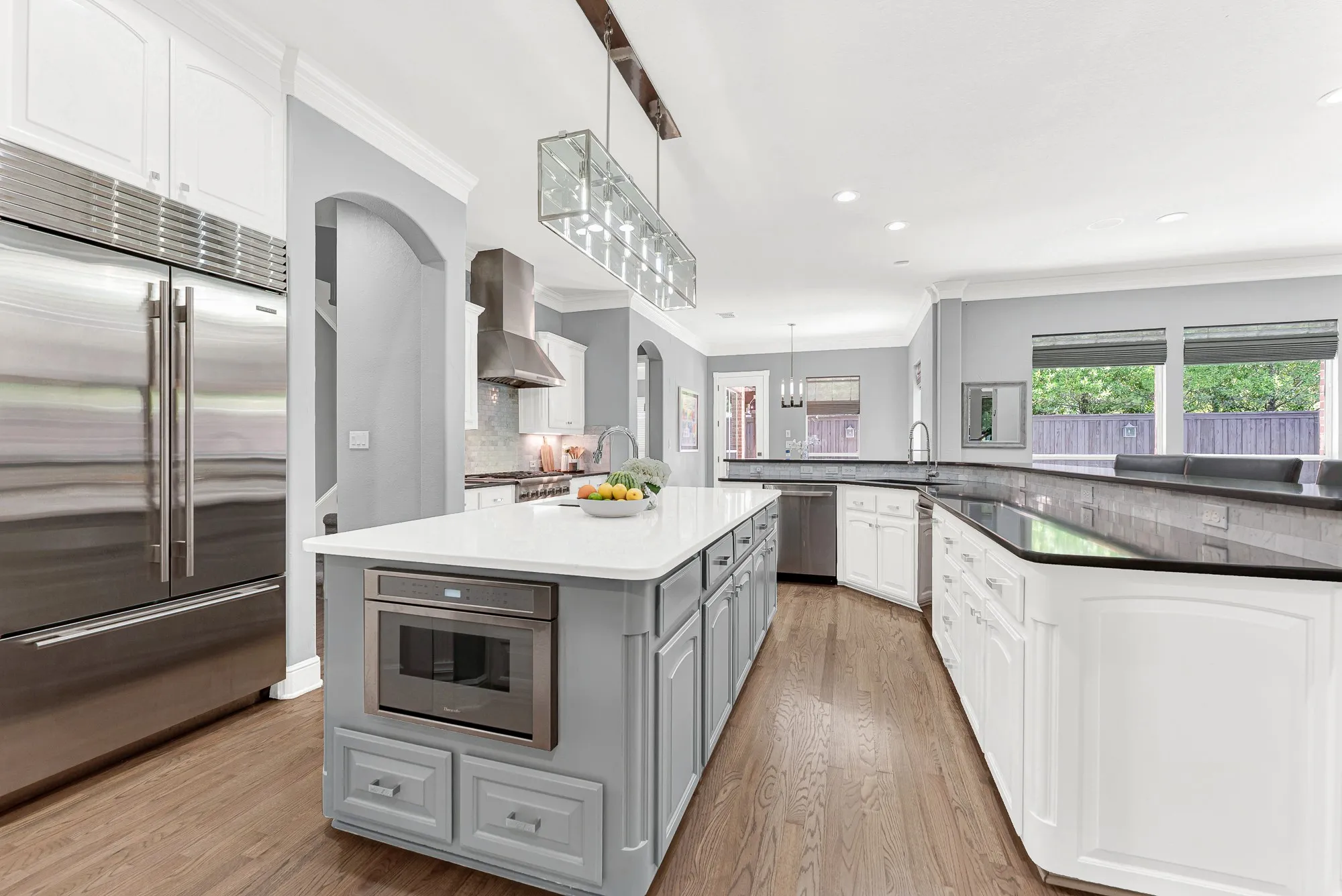 Remodeled in 2019, this kitchen showcases custom cabinetry, pristine quartz counters, and a built-in 36" Sub-Zero refrigerator. Cooking family meals becomes a delight in an open space designed for seamless movement and easy everyday gatherings.  You'll love the Thermador MicroDrawer® microwave/convection oven — opens with a simple touch and tucks seamlessly into the cabinetry, with smart sensor cooking  and conveniently positioned on the island!
