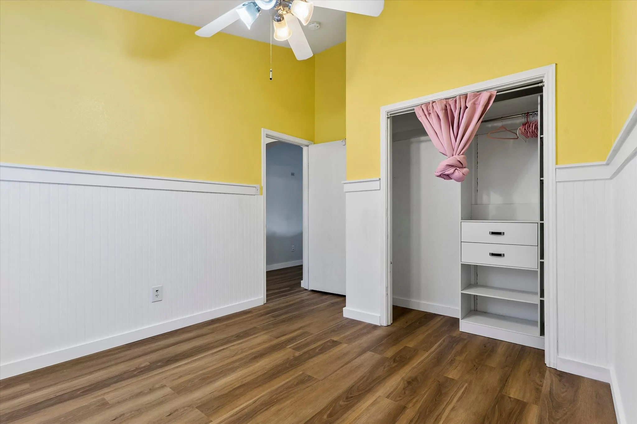 Sunny kids bedroom or office with builtins.