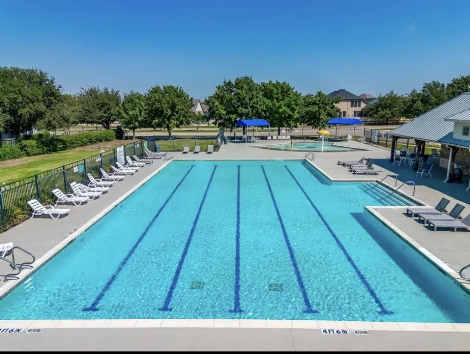 Expansive swimming pool with integrated lane lines and a dedicated shallow-entry area