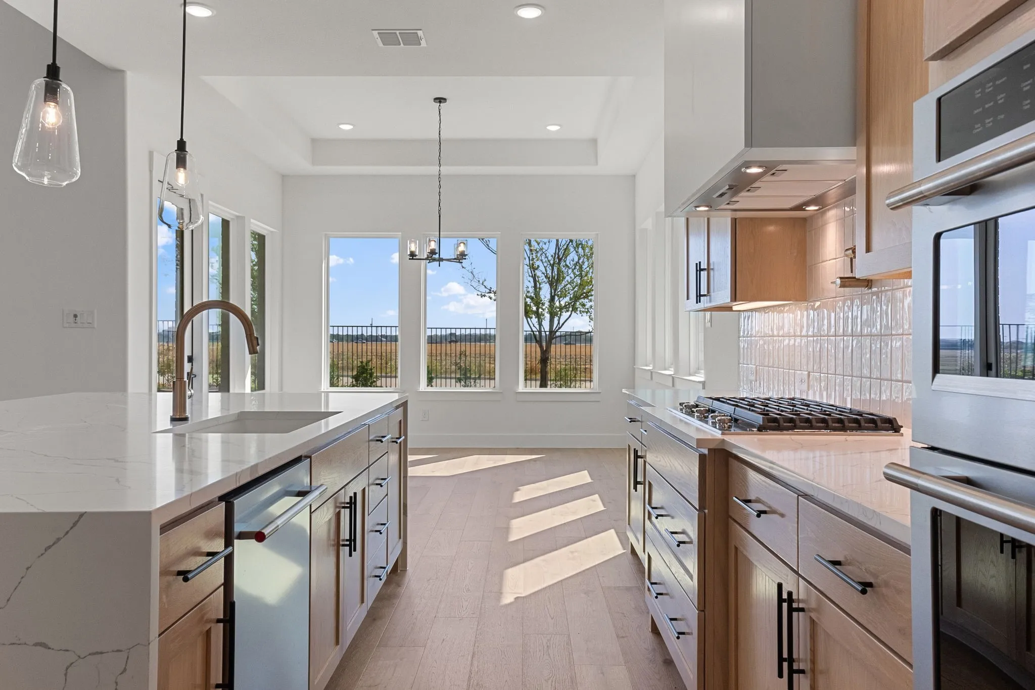 Beautiful double stacked cabinetry, gorgeous countertops and classic backsplash paired with contemporary stainless steel create a kitchen for the ages!