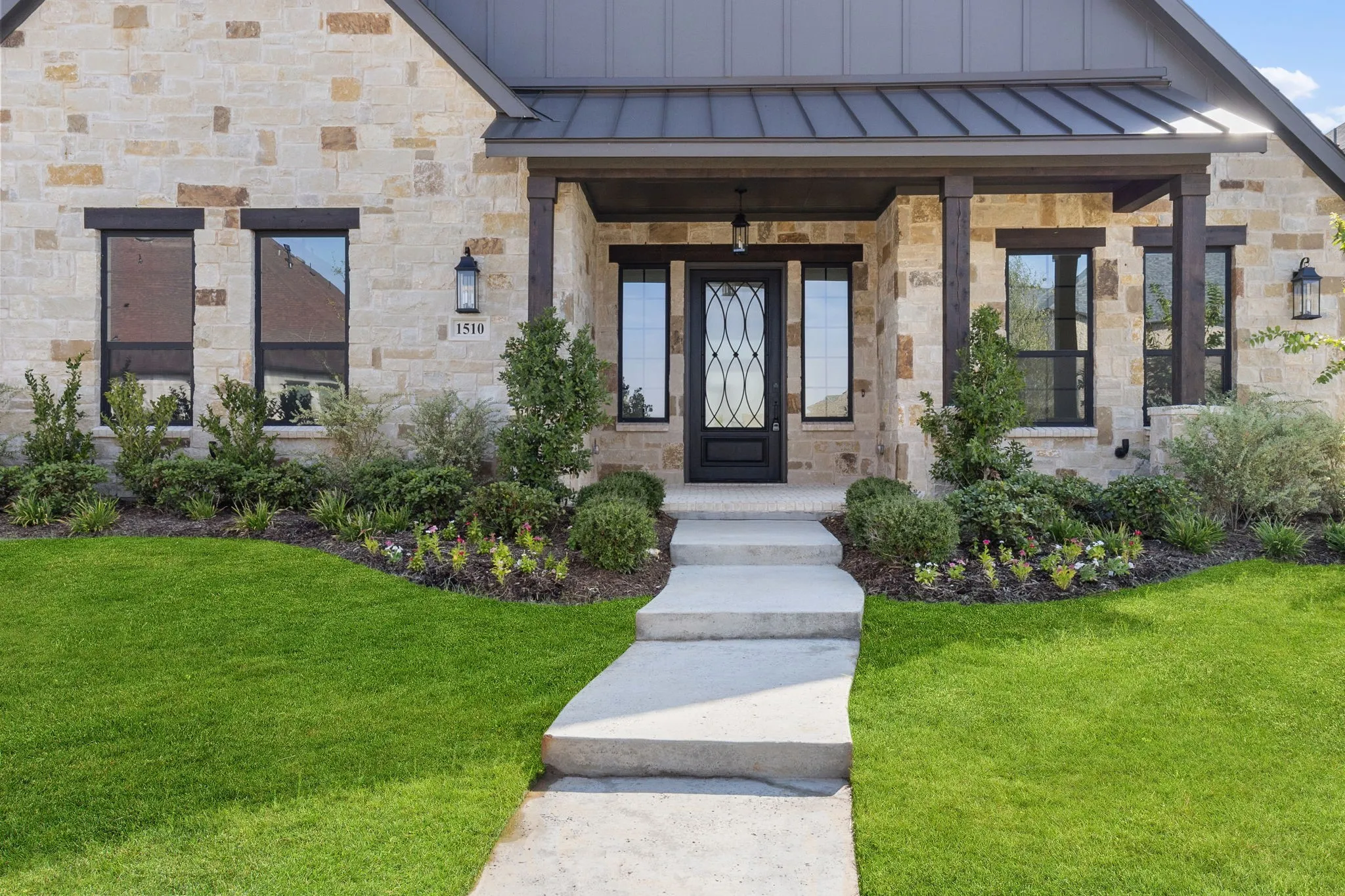 This charming covered front porch invites folks to come on in!