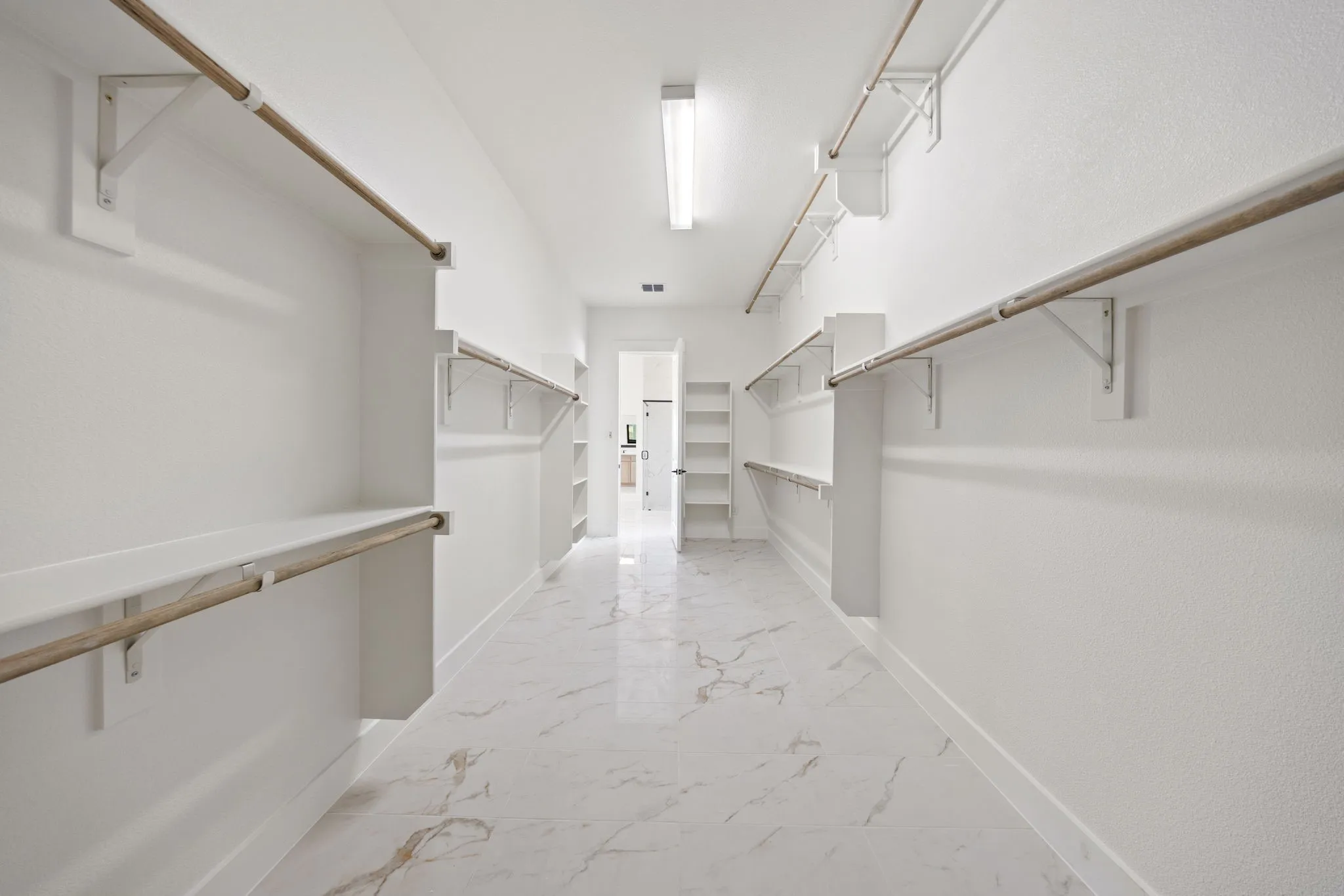 With seasonal handing space and tons of room, there'll be no fighting over closet space in this fantastic owner's closet!