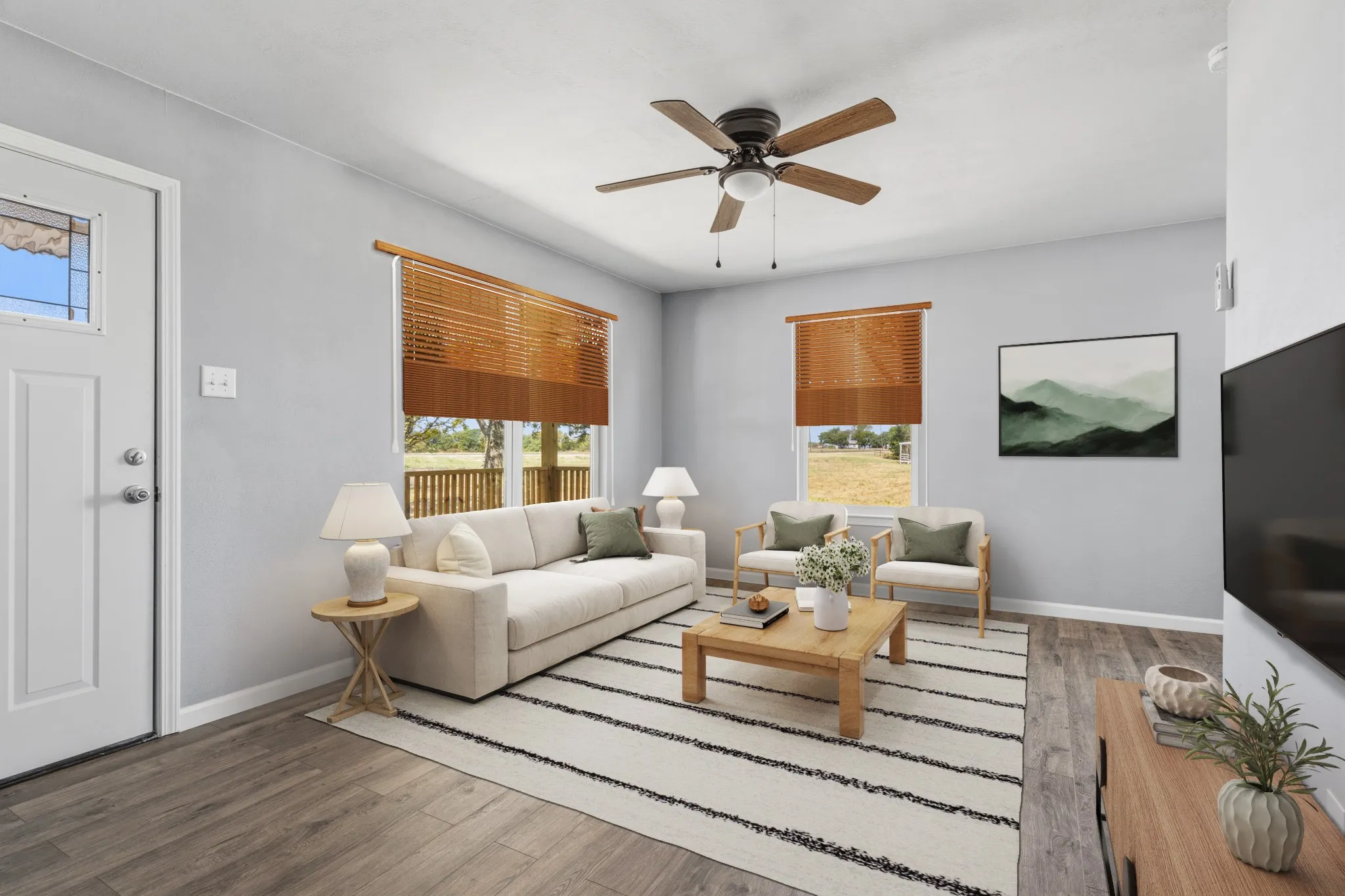 Wood-finish flooring throughout the living space, virtually staged