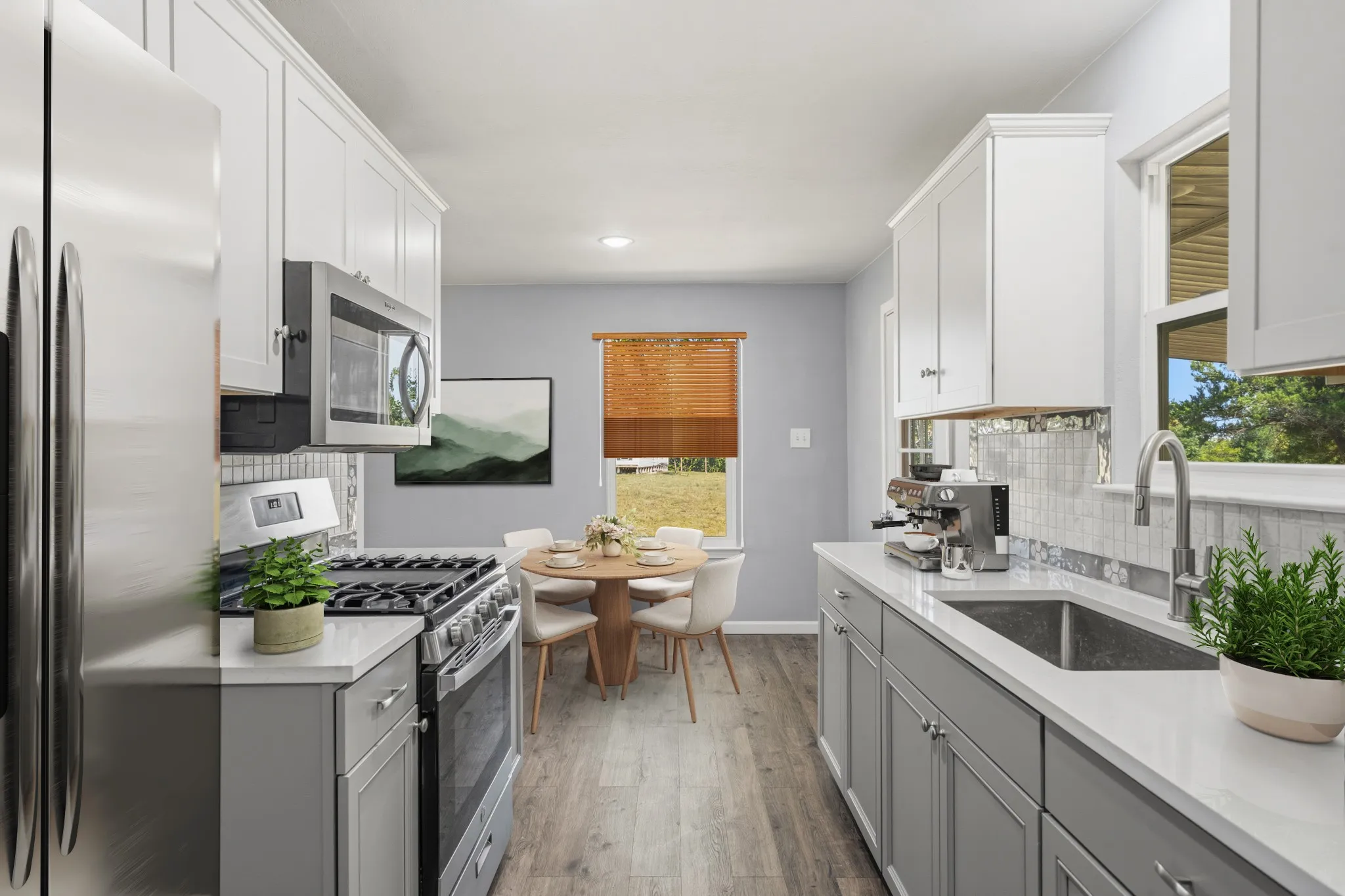 Galley kitchen featuring white upper cabinetry, gray lower cabinetry, white countertops, stainless steel appliances, and wood-finish flooring, virtually staged
