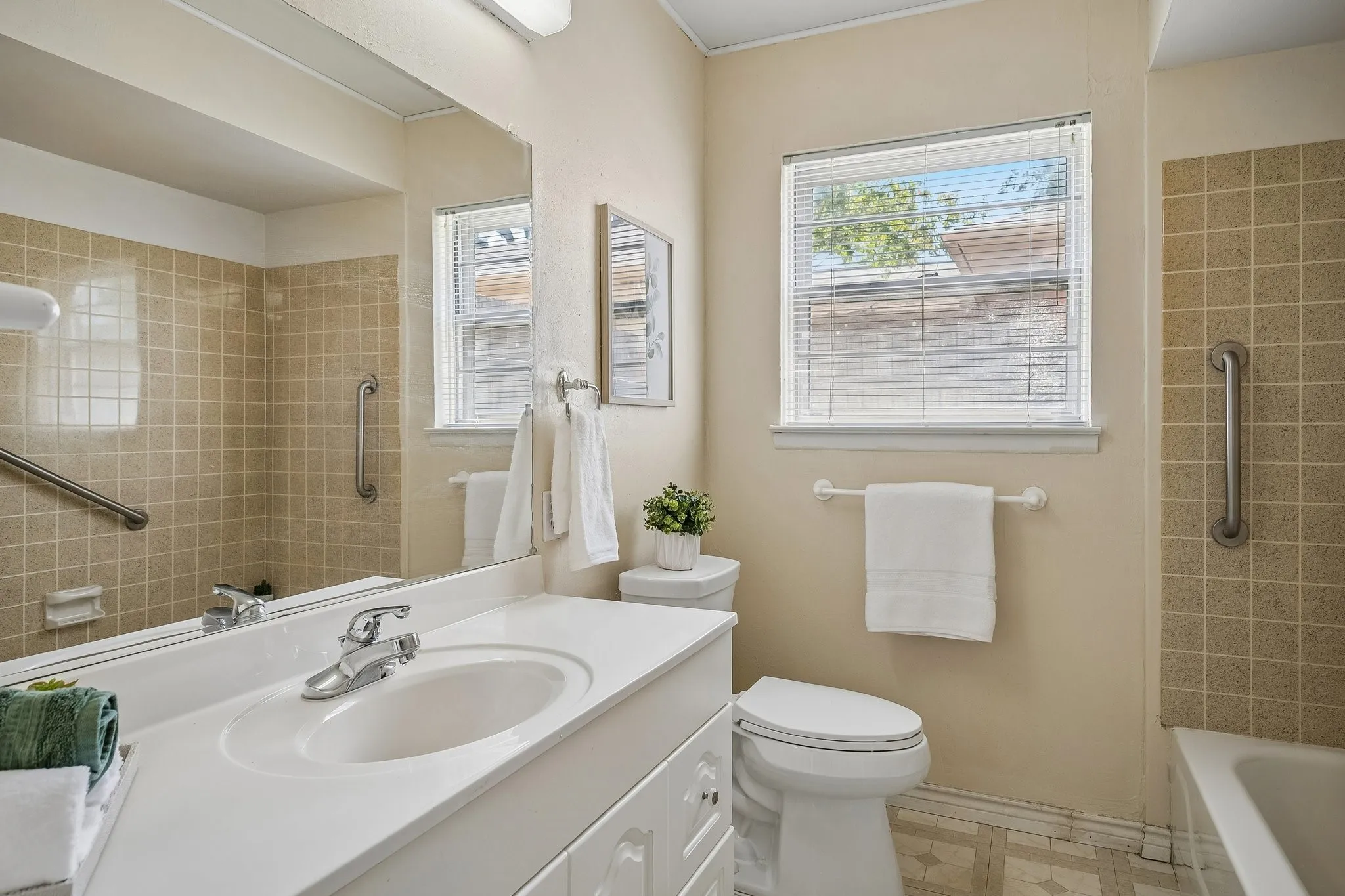 A clean and neutral aesthetic feature in this timeless hall bath.