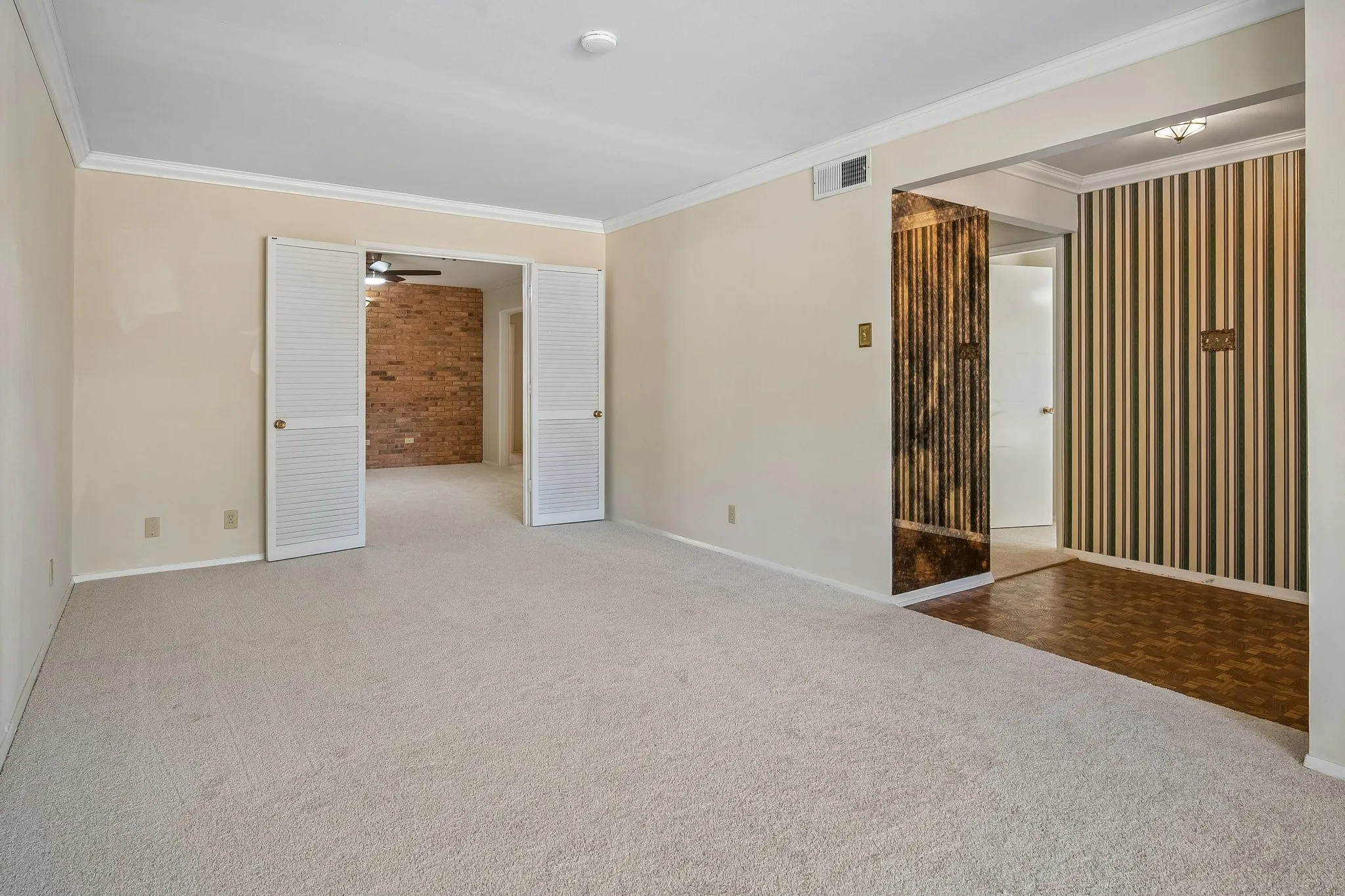 Crown molding adds architectural detail and a formal feel to this front living space.