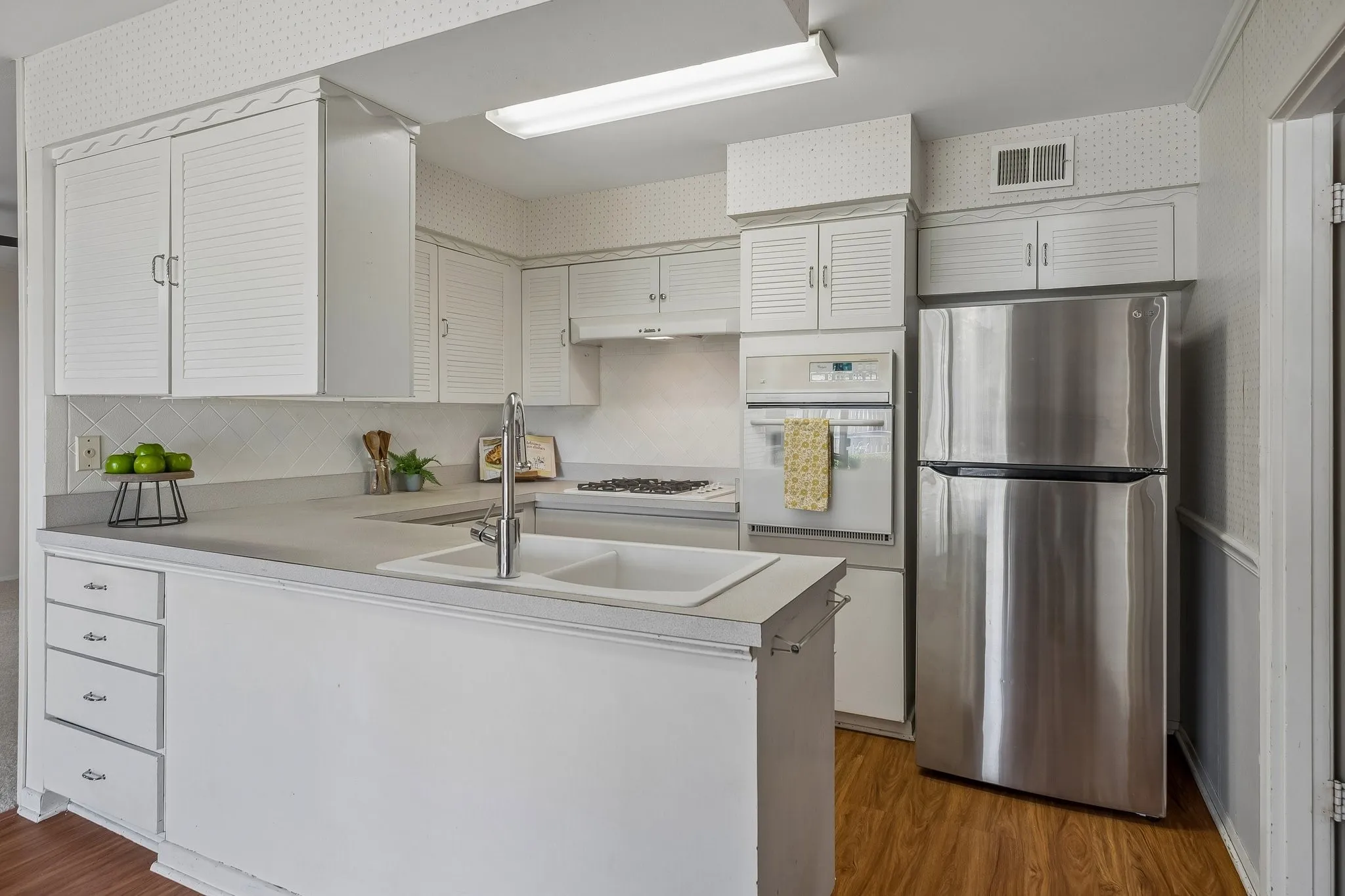 Natural light floods the kitchen and dining areas.