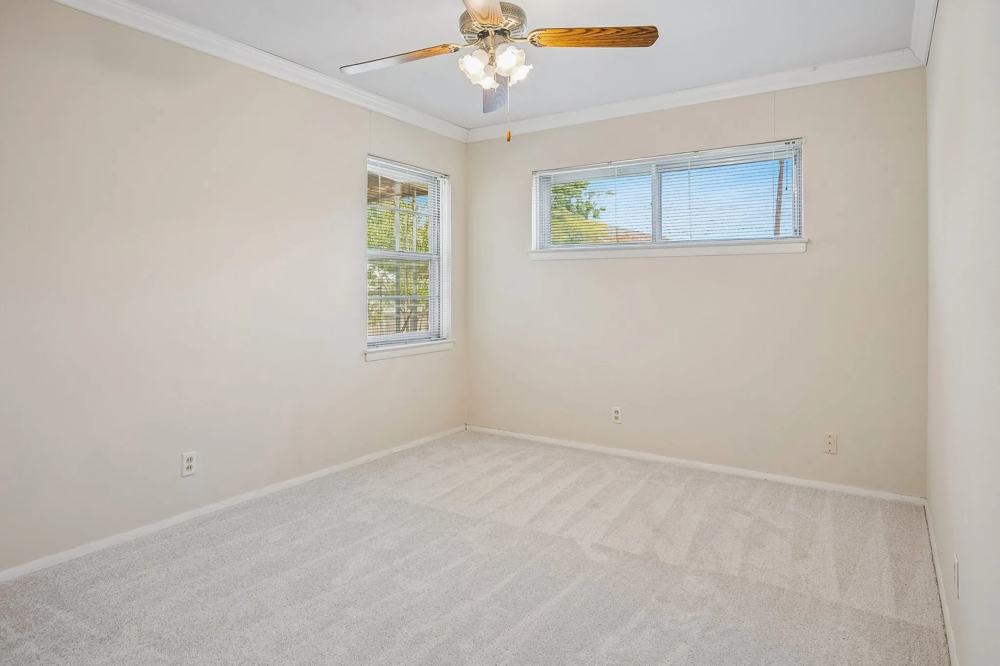 Abundant natural light and crown molding accompany each of the 4 bedrooms.