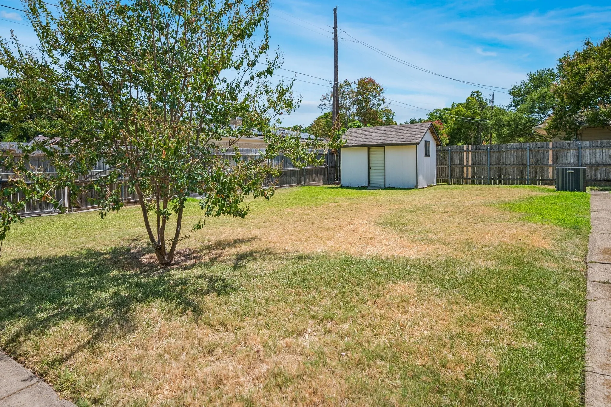 Open green space for the kids to play along with a storage shed for added utility.